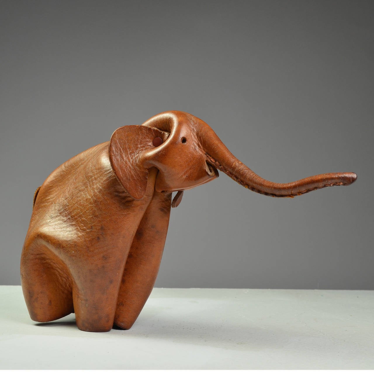 Deru a German company, Makes Beautiful Hand Craft Animals like Origami.
The metal rivet join the folding leather part of the animal, plus the sewing. 
This Elephant is more original because of the distinct trump lift up