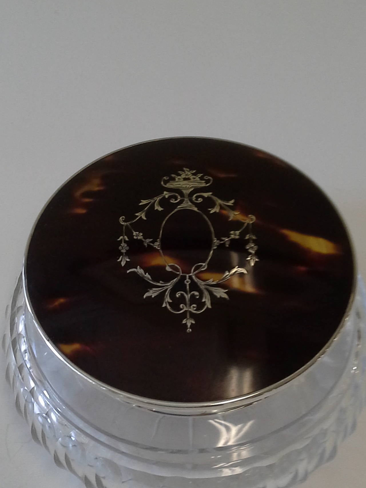 English Tortoiseshell & Sterling Silver Powder Jar with Inlaid Top, Hallmarked for Birmingham 1926, and marked Sterling silver, Made in England. The Bottom is a clear glass jar. The jar is 2 1/2"-inches high and 4 1/4"-inches in