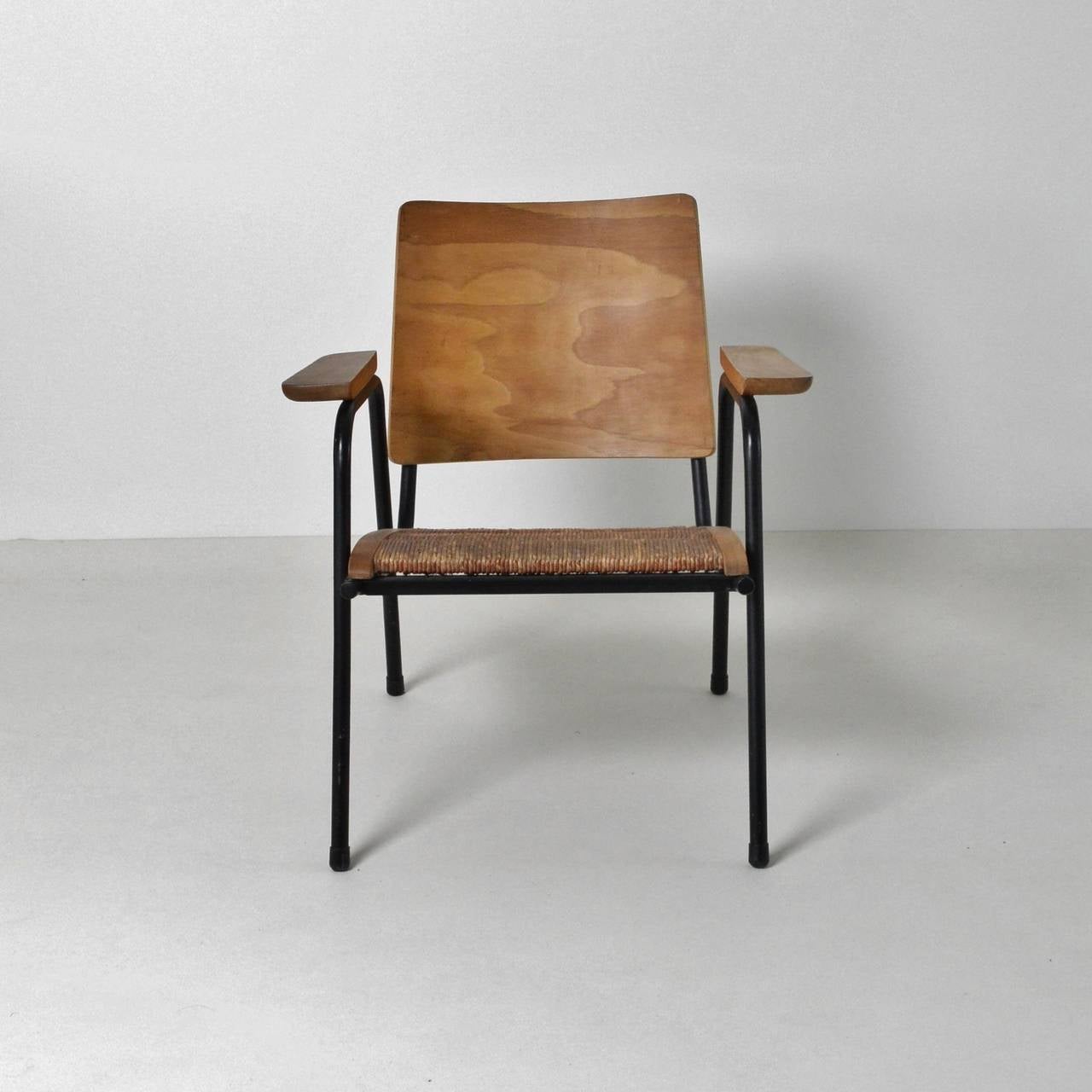 A striking pair of small lounge chairs with rush seating, Tubular frames with beech supports and armrests. The bent ply backs have an unusual and vivid veneer. Bought from France and believed to be French as they appear to have been influenced by