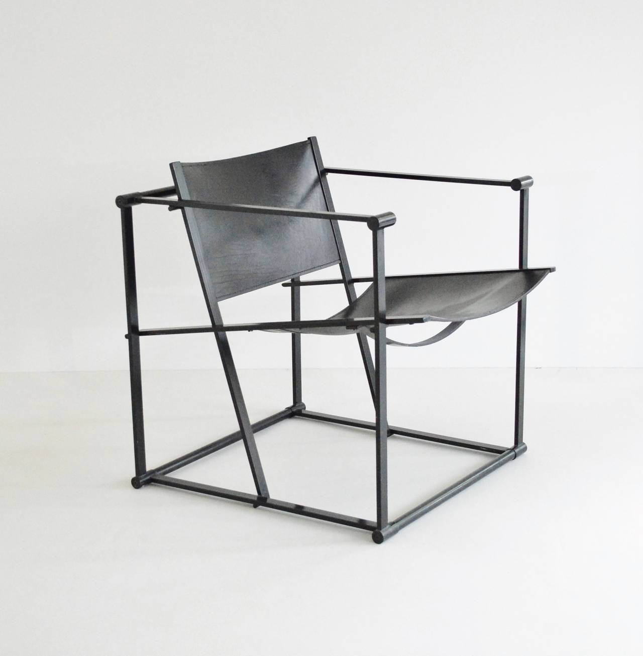 A geometric chair constructed from folded black steel with slung black leather seating. Following in the tradition of the De Stijl movement the FM60 / FM61 / FM62 model cube chairs were inspired by the designs of Gerrit Rietveld. The Cube chair was