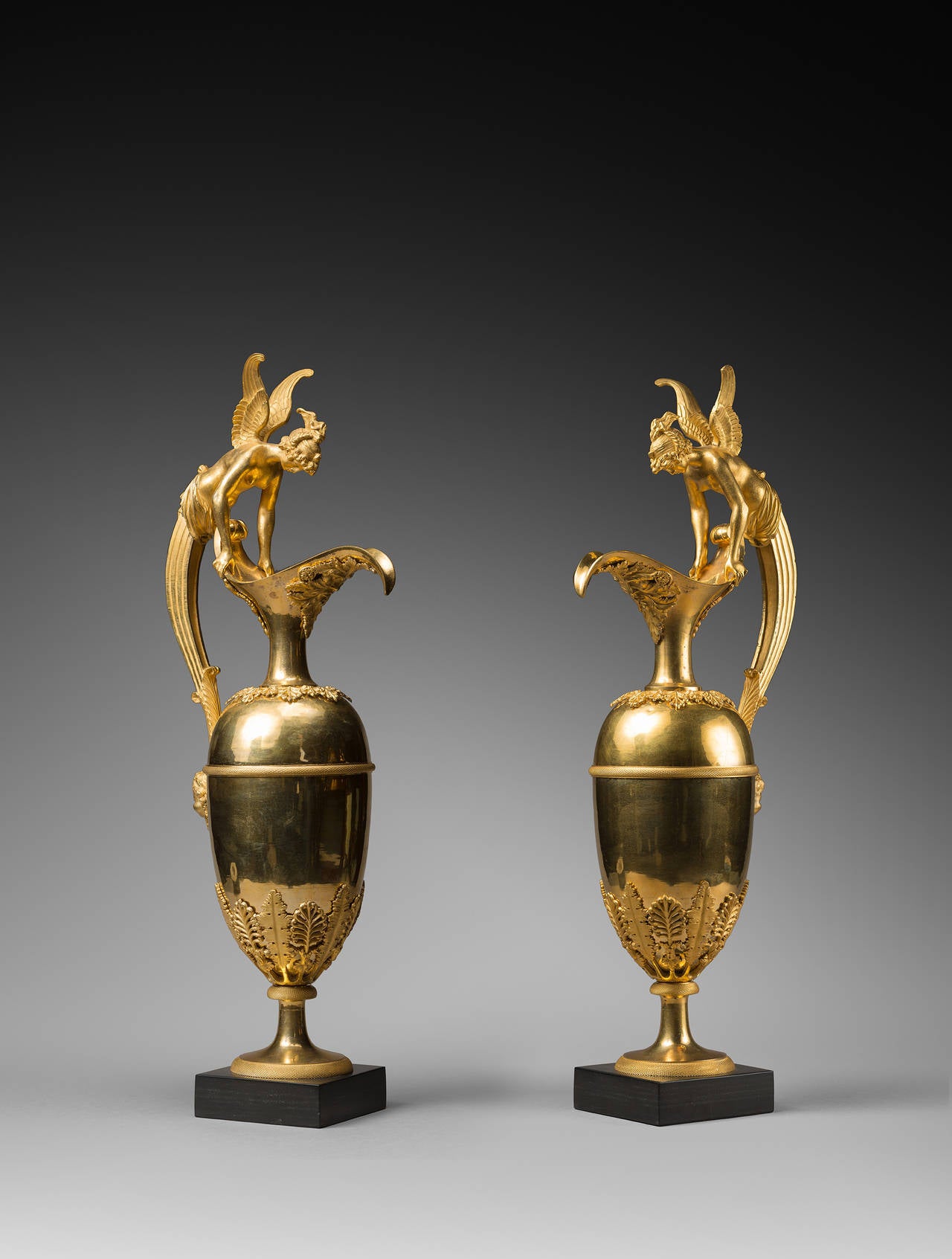 Attributed to Claude Galle

A Pair of Empire Gilt Bronze Ewers Attributed to Claude Galle
Paris, circa 1810 

Height 57 x 10.5 x 10. 5 cm (base) each

Of elongated baluster form, the collars and bases of these ewers are mounted with stylized