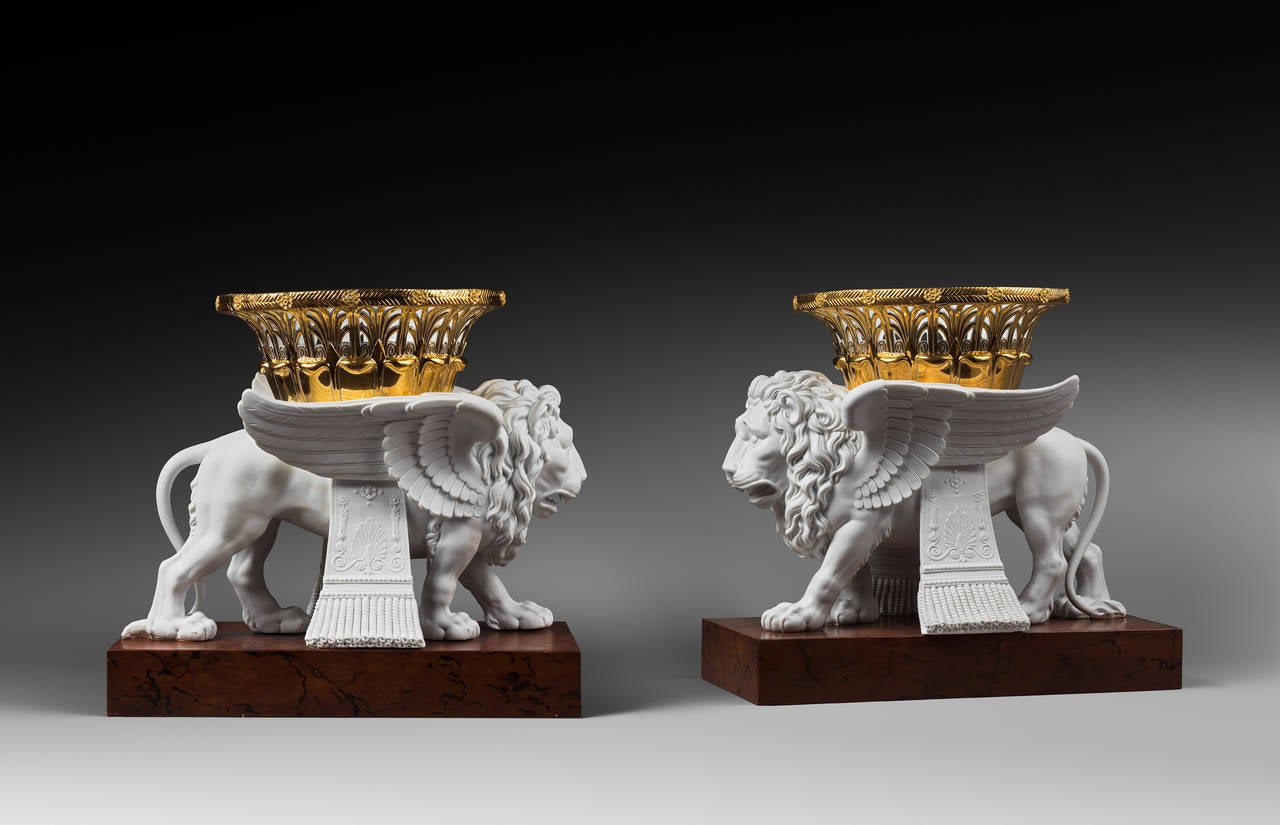 After a Model by Alexandre-Evariste Fragonard 

Rare Pair of Sèvres Bisque Porcelain Winged Lions 
Bearing Gilt Baskets 

Sèvres Royal Manufactory, Restoration period, circa 1826-1828
Height 35cm; width 38.7 cm; depth 19 cm

One of the