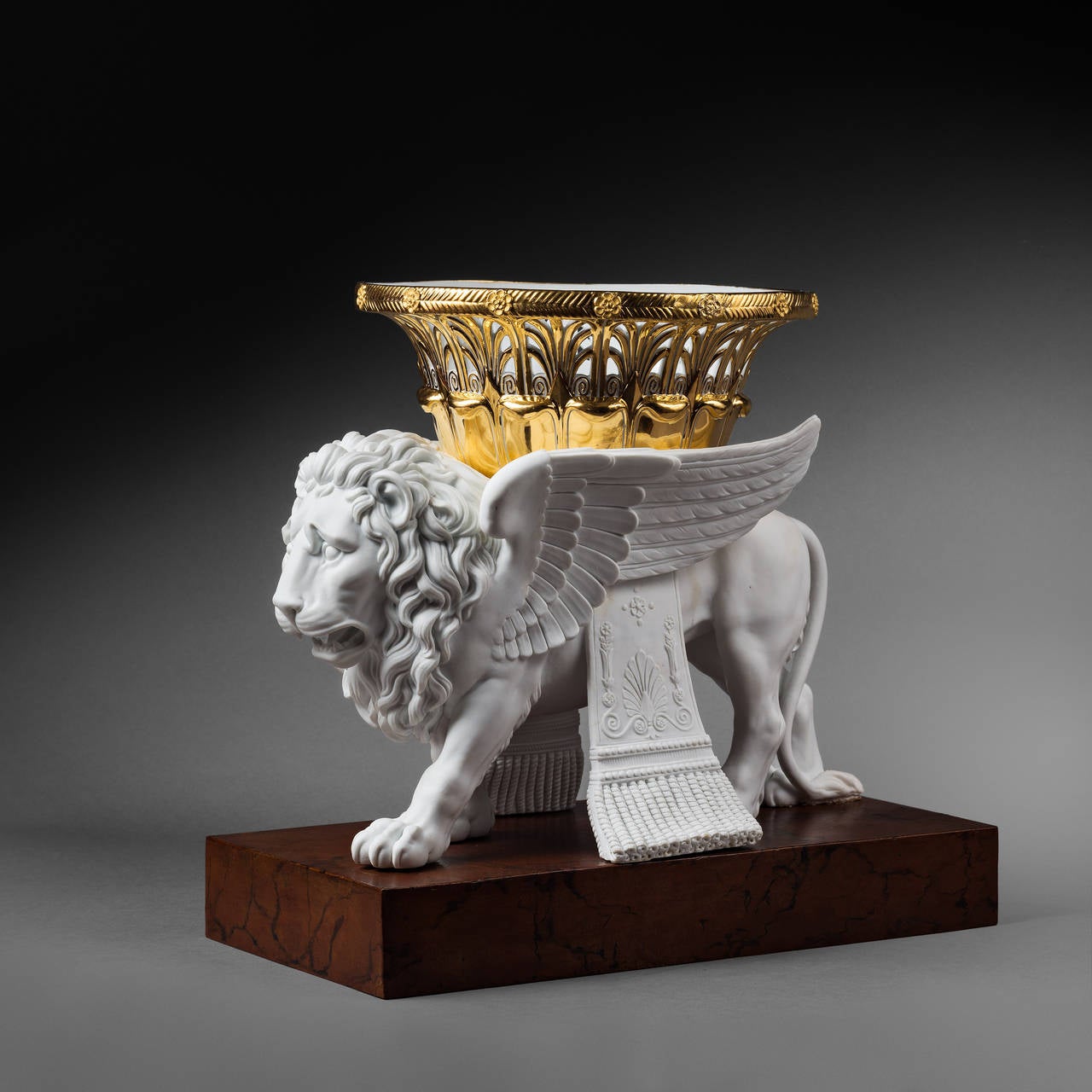 French Pair of Sèvres Bisque Porcelain Winged Lions Bearing Gilt Baskets For Sale