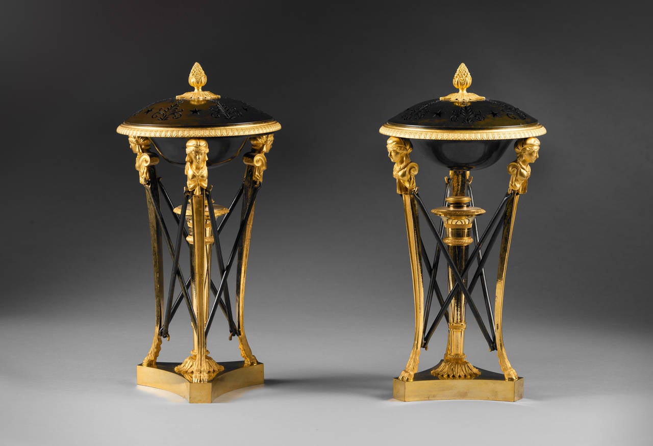 Attributed to Claude Galle 

A Rare Pair of “Athénienne” Incense Burners 

Paris, early Empire period, circa 1805
Height 36.5 cm; diameter 17.5 cm. 

These unusual gilt and patinated bronze incense burners are in the form of tripods, with
