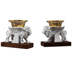 Pair of Sèvres Bisque Porcelain Winged Lions Bearing Gilt Baskets