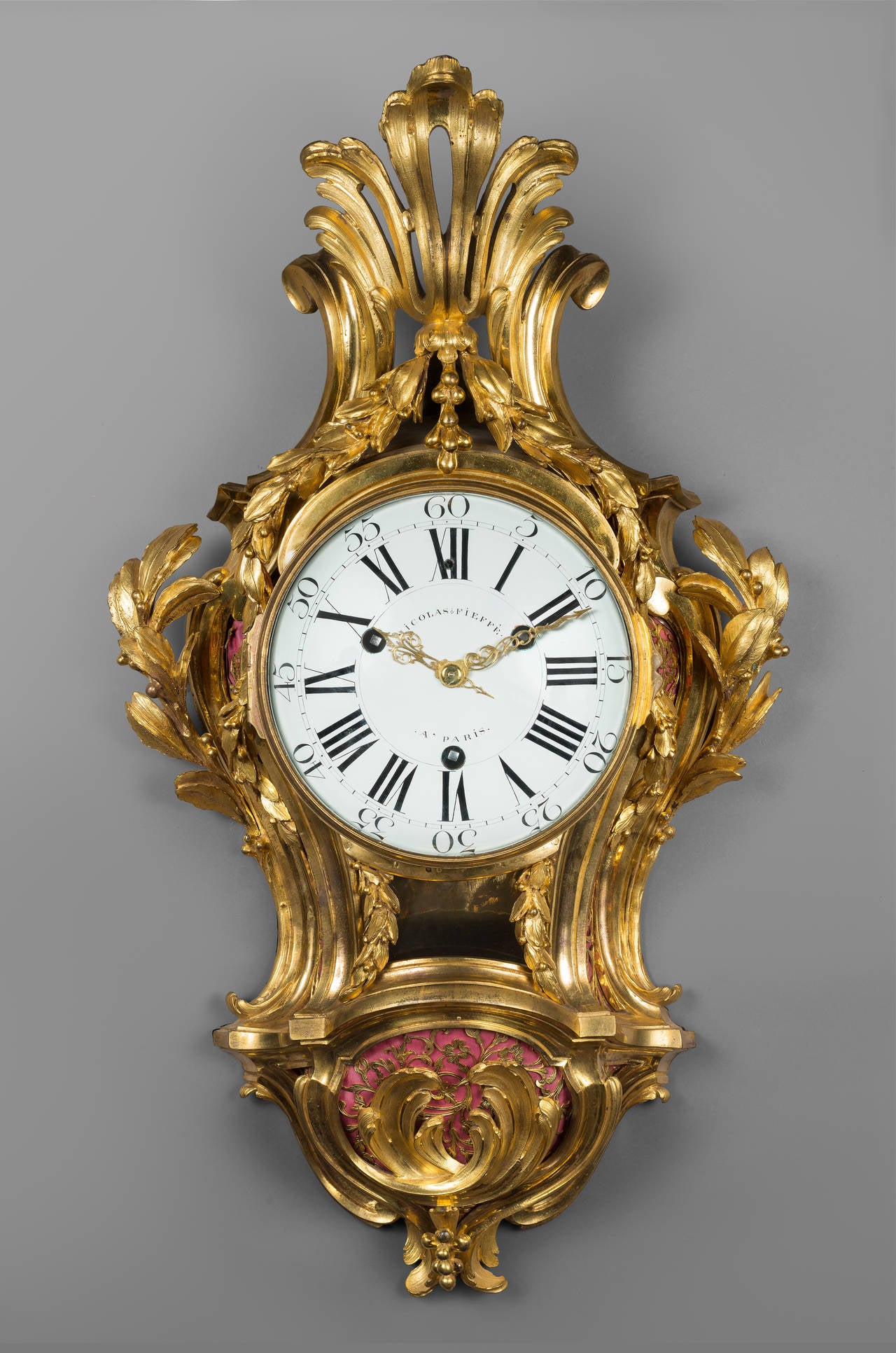 Nicolas-Jean Fieffé 
Case Attributed to Jean-Joseph de Saint-Germain

Important Chased Gilt Bronze Wall Cartel 

Paris, Louis XV period, circa 1755-1760
Height 82 cm; width 47 cm; depth 14 cm

The enamel dial, signed “Nicolas Fieffé à