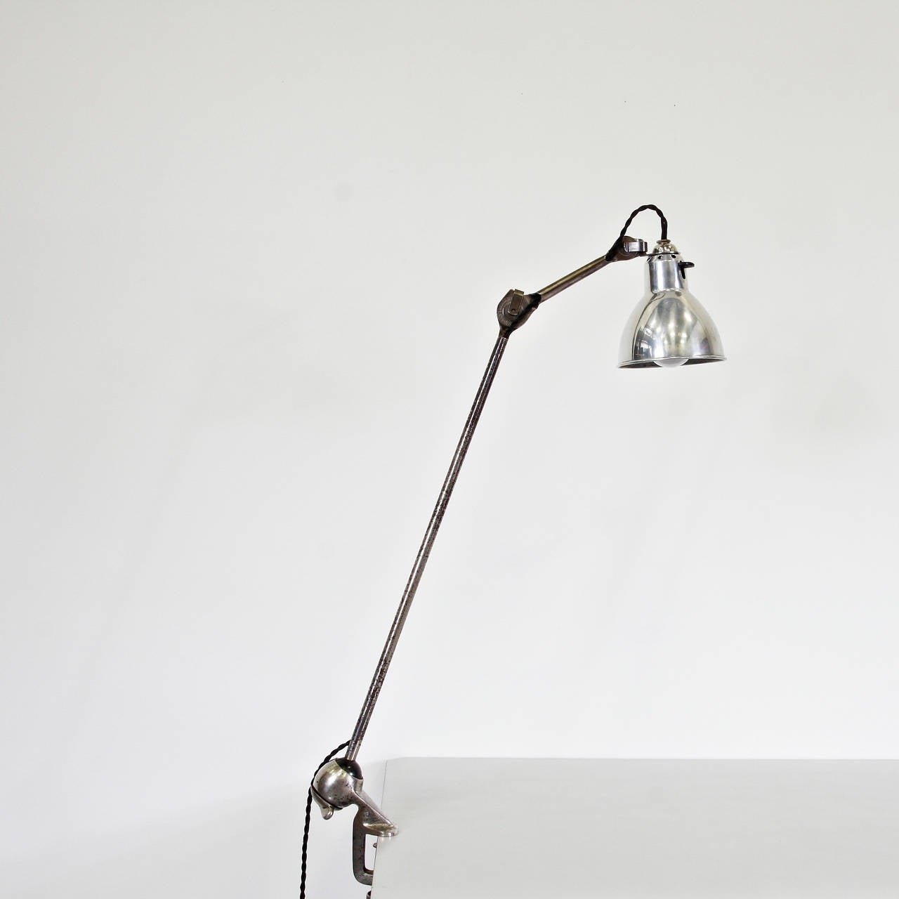 Table Lamp designed by Bernard-Albin Gras.
Manuactured by Gras (France) around 1930.
Aluminium and steel.

In good original condition, with minor wear consistent with age and use, preserving a beautiful patina.

In 1922 Bernard-Albin Gras