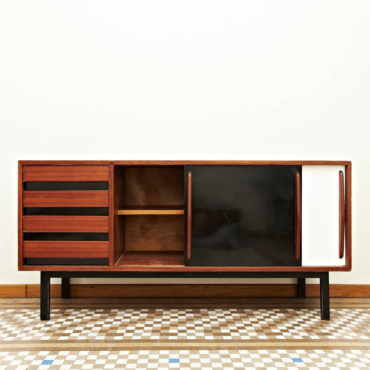 Sideboard designed by Charlotte Perriand, circa 1950. 
Edited by Steph Simon (France). 
Steel base, wood structure and grips, lacquered sliding doors. 

Provenance: Cansado, Mauritania (Africa).

In good original condition, with minor wear