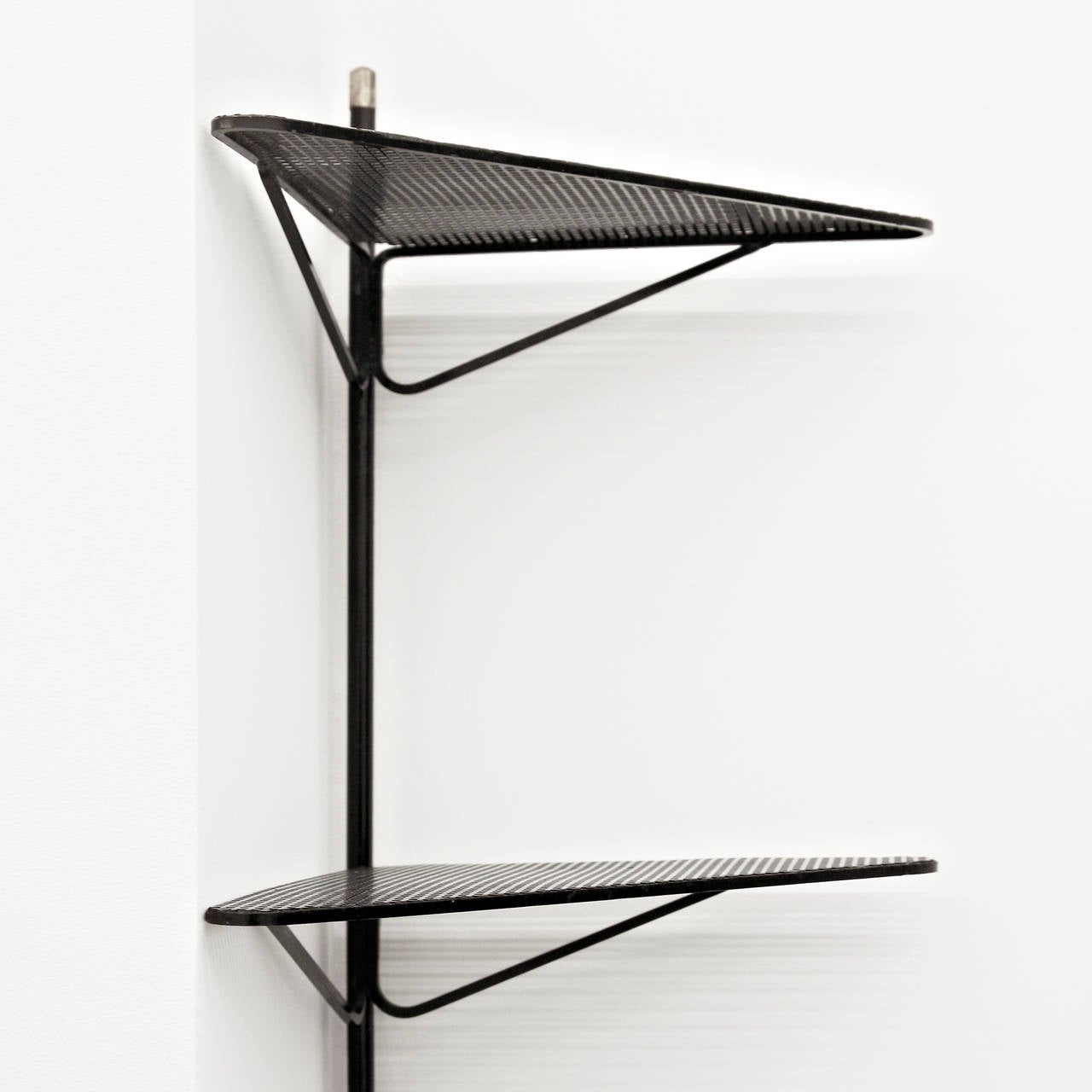 Corner Shelf designed by Mathieu Matégot.
Manufactured by Ateliers Matégot (France) circa 1950.
Lacquered perforated metal with original paint.

In good original condition, with minor wear consistent with age and use, preserving a beautiful