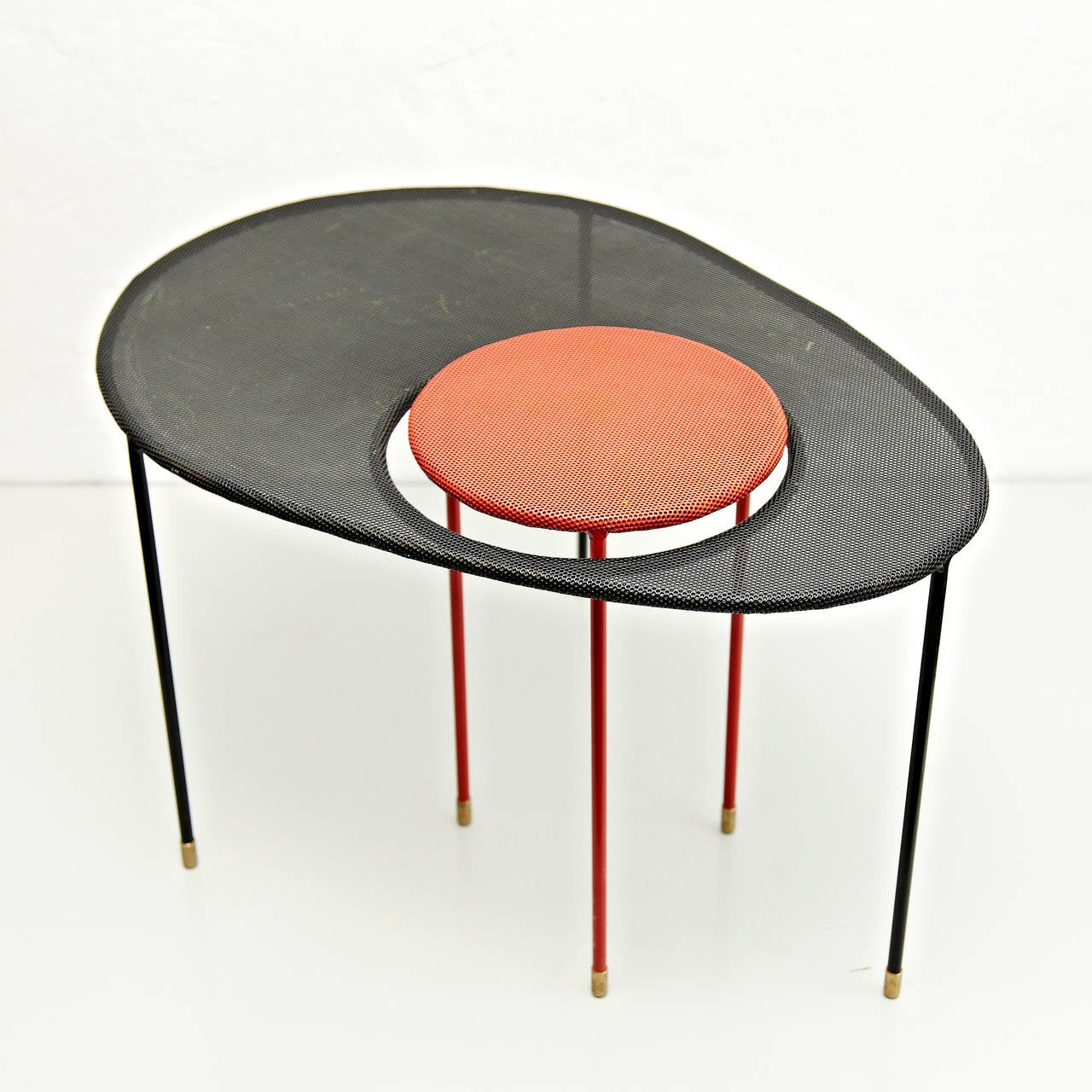Nesting tables, model Kangourou, designed by Mathieu Matégot.
Manufactured by his son Patrice Matégot, France, circa 2000 before it went into production again.
Folded, perforated metal, lacquered in red and black.

In good original condition,