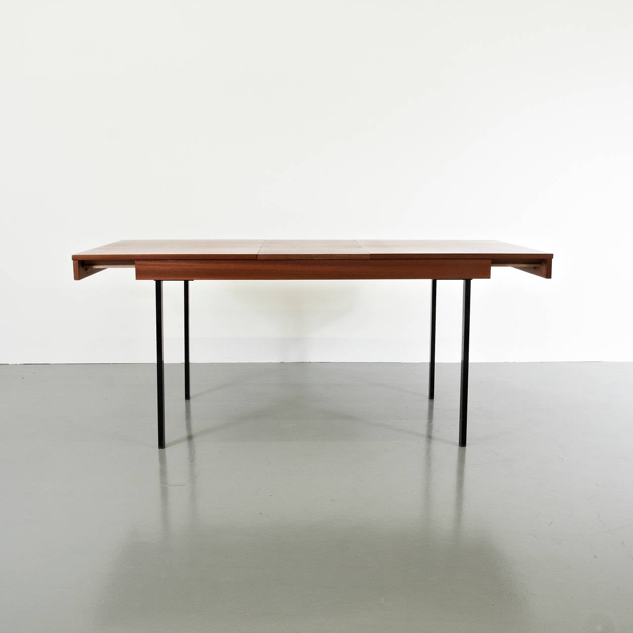 Adjustable Extension Dinning Table designed by Pierre Guariche.
Manufactured by Meurop (France) around 1950.
Bent and painted iron frame, wood table top.

In good original condition, with minor wear consistent with age and use, preserving a nice