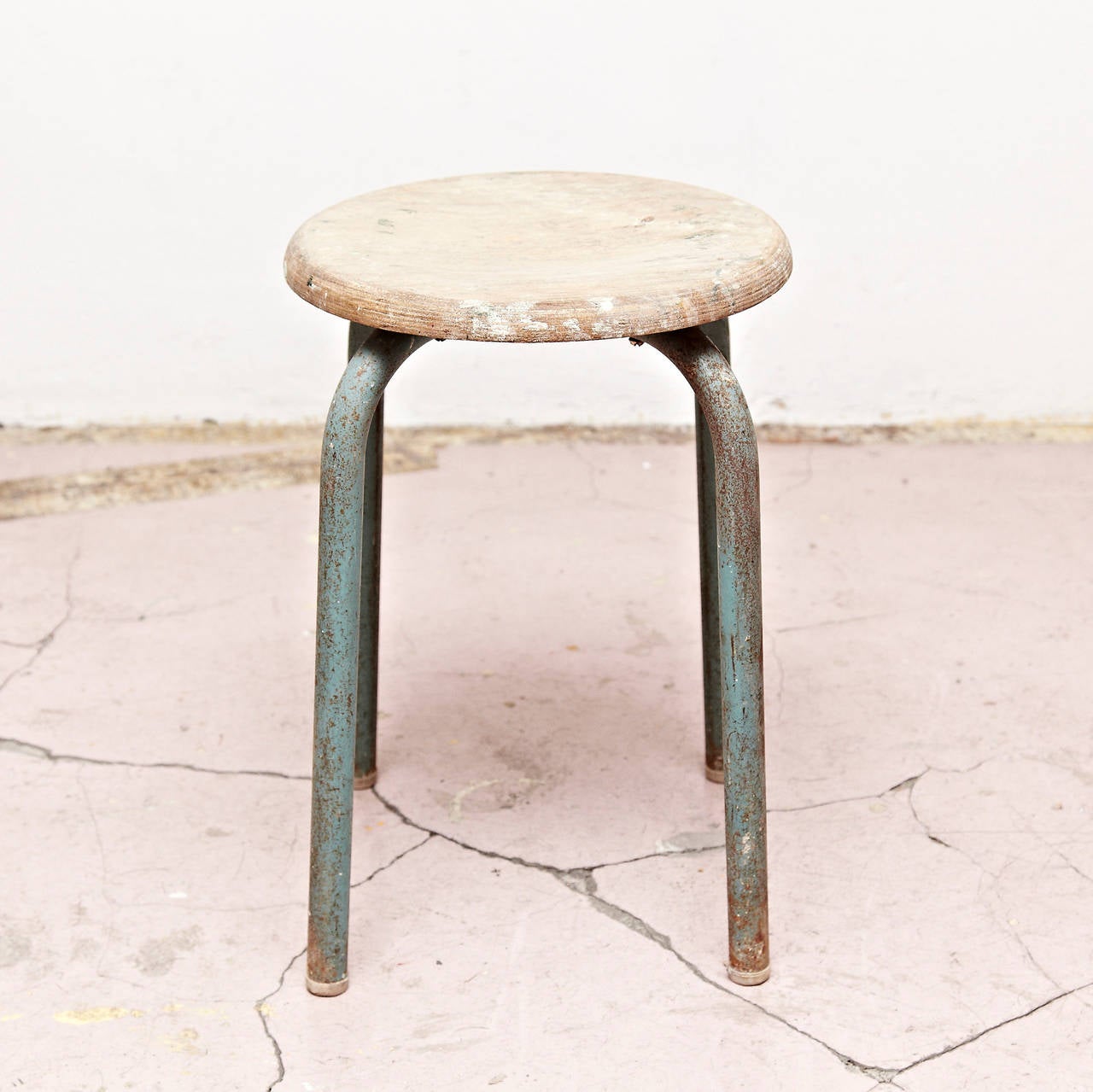 Stool design attributed to Jean Prouvé, circa 1950.
Manufactured in (France).
Lacquered metal base and laminated wood seat.

In good original condition, with minor wear consistent with age and use, preserving a beautiful patina.

.
