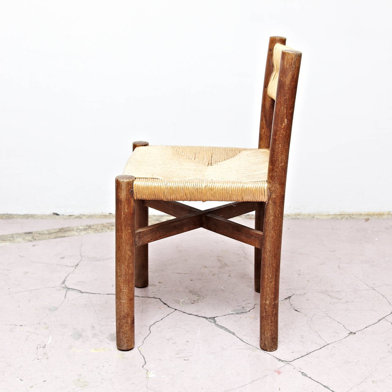 Dining chair, model Meribel, designed by Charlotte Perriand, circa 1950.
Manufactured by Georges Blanchon (France)
Wood base and legs, and original rush seat and backrest.

In original condition, with minor wear consistent with age and use,