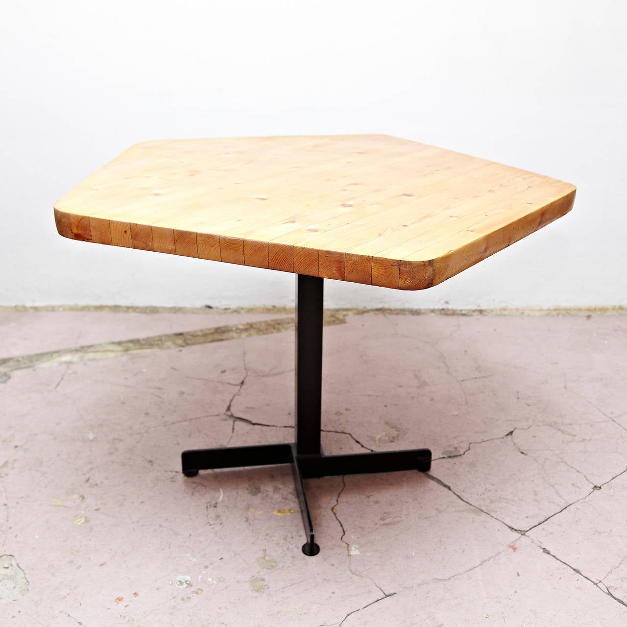 Pentagonal dinning table designed by Charlotte Perriand for Les Arcs ski Resort around 1960, manufactured in France. 
Lacquered metal base, pine wood table top. 

In good original condition, with minor wear consistent with age and use, preserving