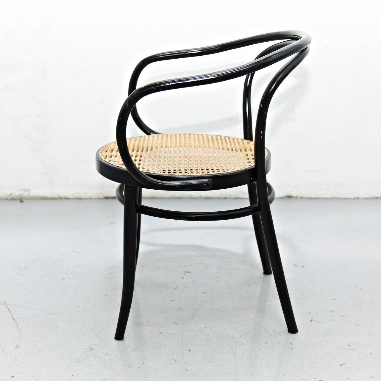 Thonet 209 by Auguste Thonet for Thonet manufactured In Germany.
Bentwood and rattan.

In good original condition, with minor wear consistent with age and use, preserving a beautiful patina.

In the 1830s, Thonet began trying to make furniture
