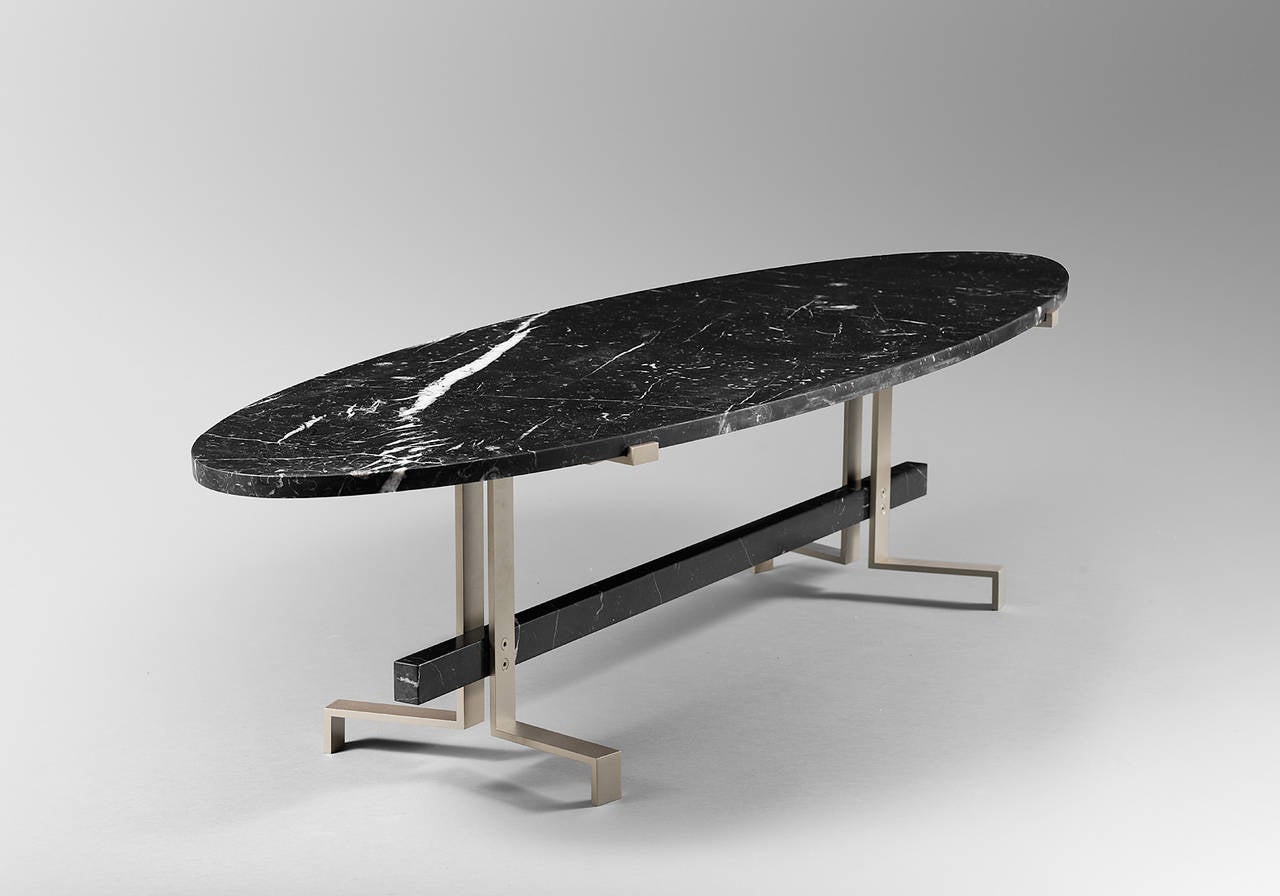 Coffee table, soft and solid black marquina marble platter and beam. Table plate thickness 2 cm.
Beam dimensions: Width 1090 cm, depth 30 cm, height 40 cm.
Base in solid aluminium, warm grey shade, anodized lacquer.
This piece is signed and part