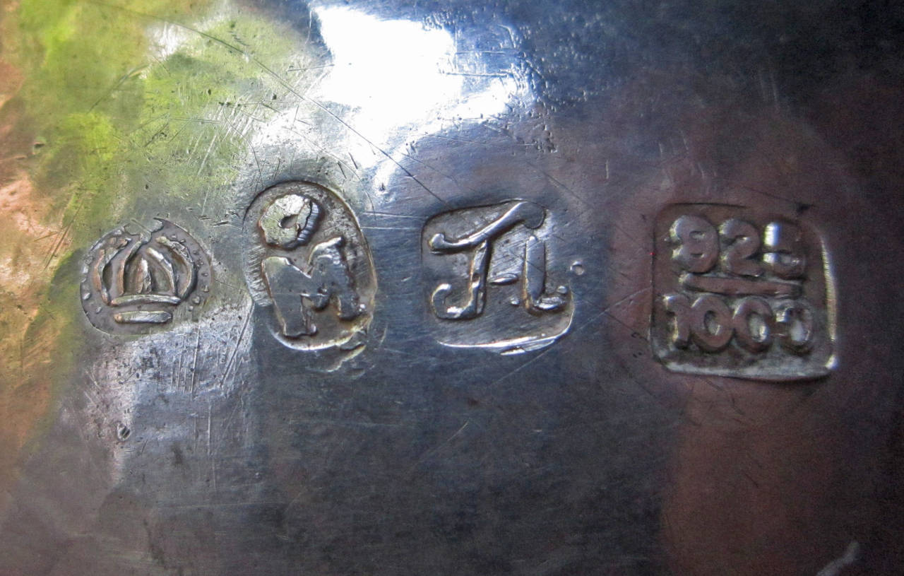This unusual egg form casket is marked with the OM for Mexico City silver but also with the numbers 925/1000 which is a 20th C. marking.  There is a form of crown and initials but none were found in my research to match these marks.
So we can only