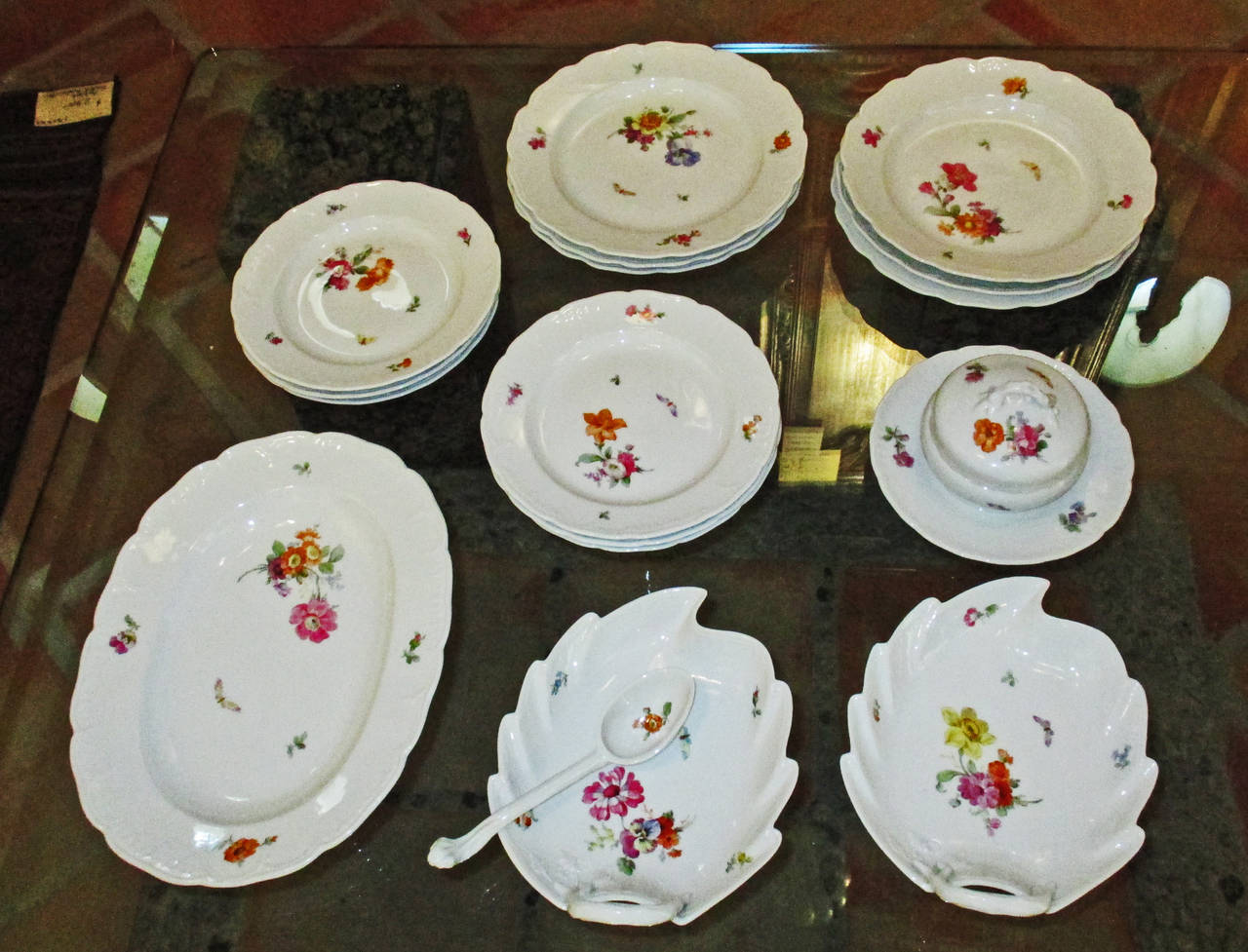 These fine dishes are hand decorated with flowers and insects. Their Iron Cross mark indicates they were made after 1914.  The dimensions are as follows:  9.5