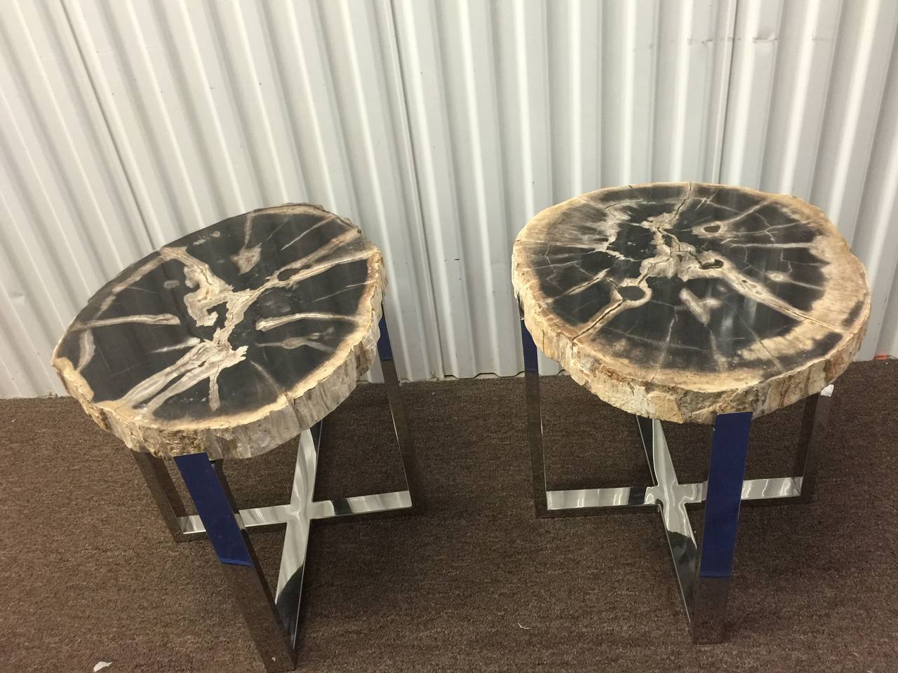 A pair of organic modern style end or side tables with chrome over steel base and petrified slab wooden 2