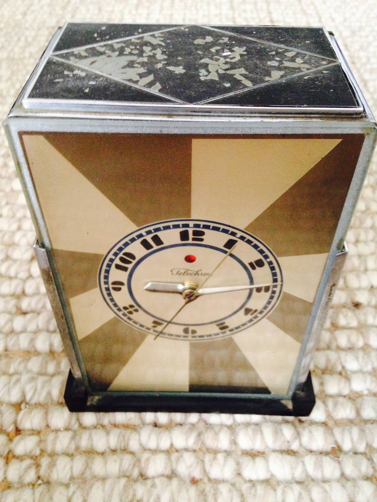 This is a great iconic clock designed by Paul Frankl for the Telechron Clock Company in the 1930s. Consisting of chromed and enameled brass with a great cubistic design and highly
stylized numbers on the clocks face. In original condition there is