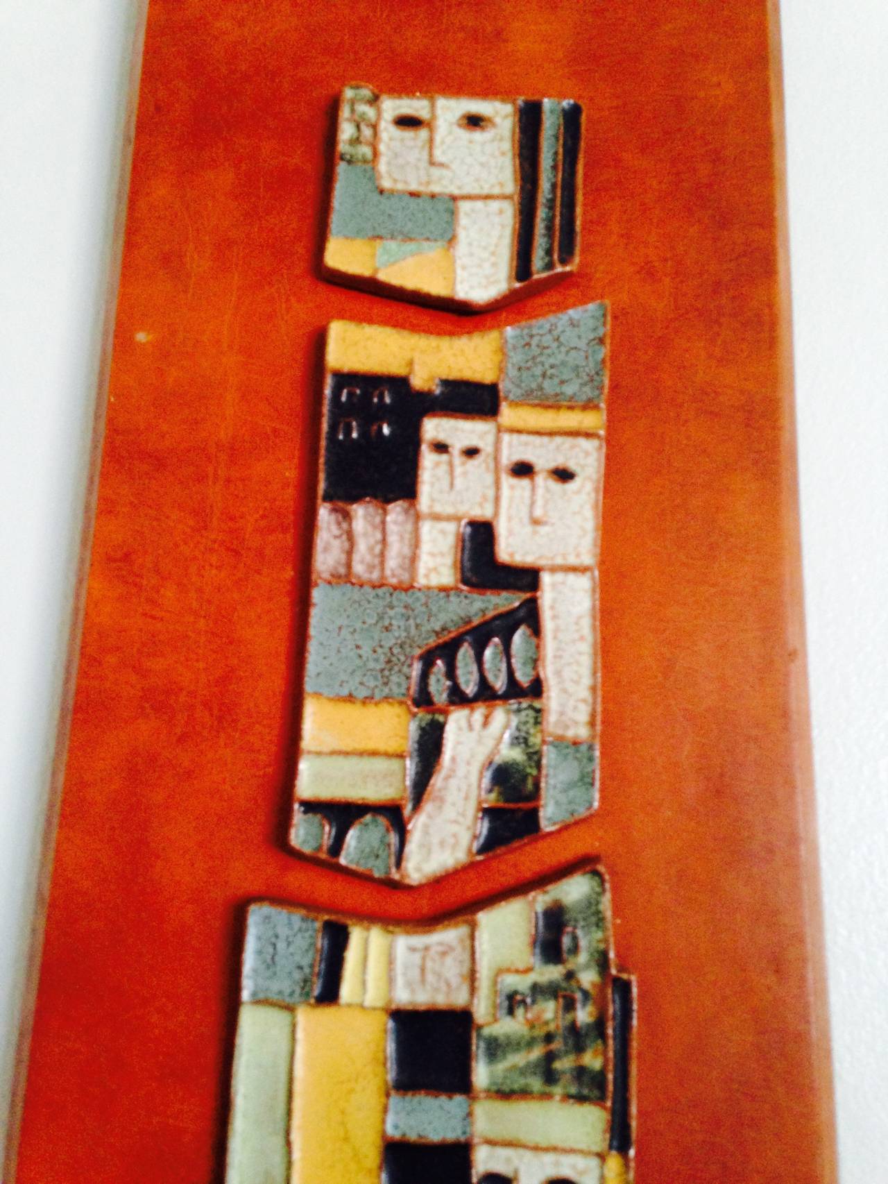 A great strong modernist design pair of ceramic plaques mounted on finished wood plaques created by Harris Strong the famed Mid-Century ceramicist. Nicely mounted with abstract figures these are a great wall accent for any Mid-Century Modern decor.