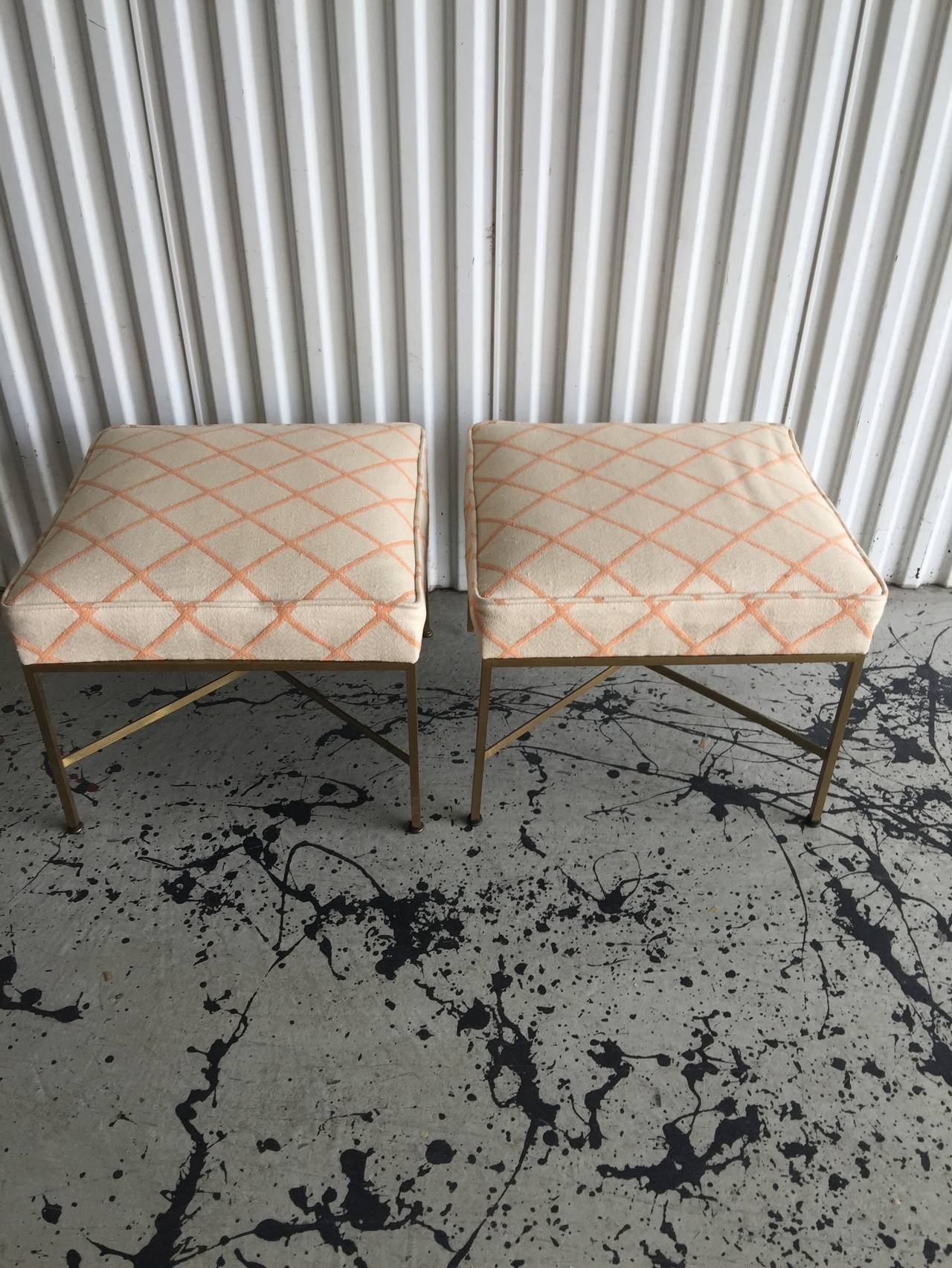 A pair of X Cross Stretcher brass square tubular stools designed by Paul McCobb circa 1950's with the original fabric in very nice condition.
