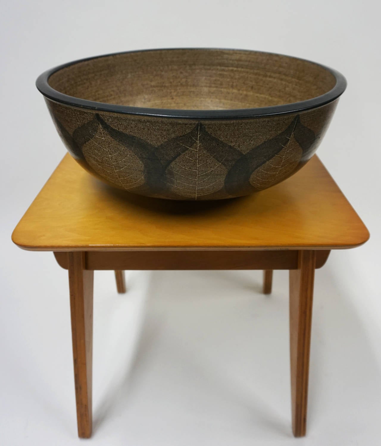 Monumental ceramic bowl by master California ceramic artist Harrison Mcintosh. Brown and black glaze with incised leaf pattern. Signed with the artist's chop mark.