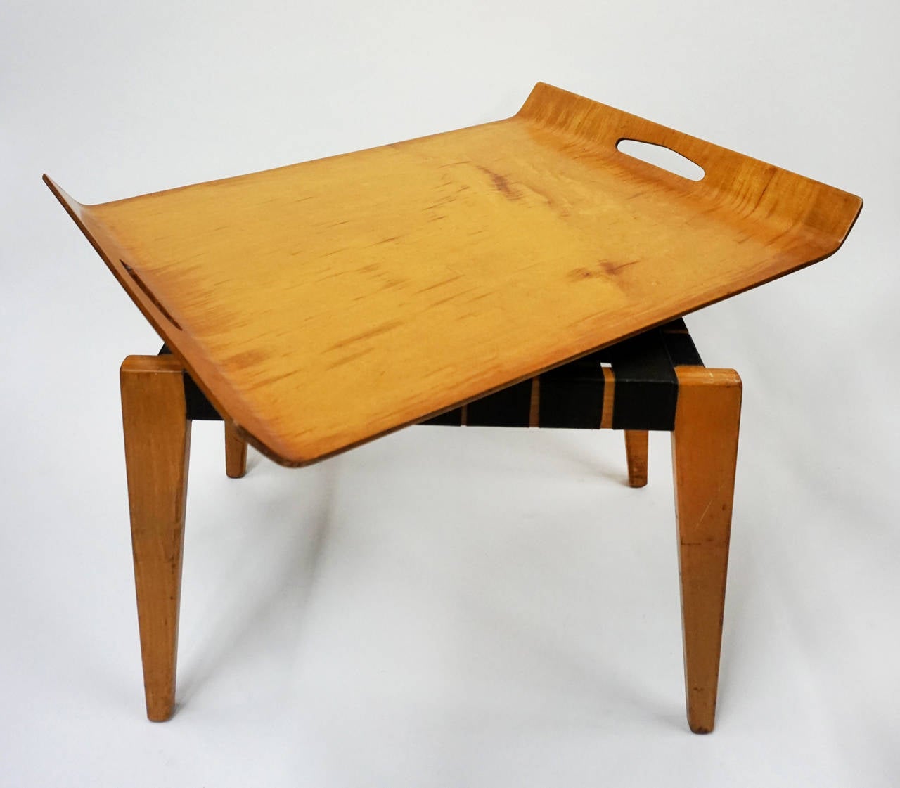 Bentwood tray on a webbed table by Abel Sorenson for Knoll. Original straps. Produced for only four years (1946-1950).

Tray: 24.5″ W x 19″ D x 1.75″ H. 
Stool: 19″ W x 14.75″ D x 16″ H