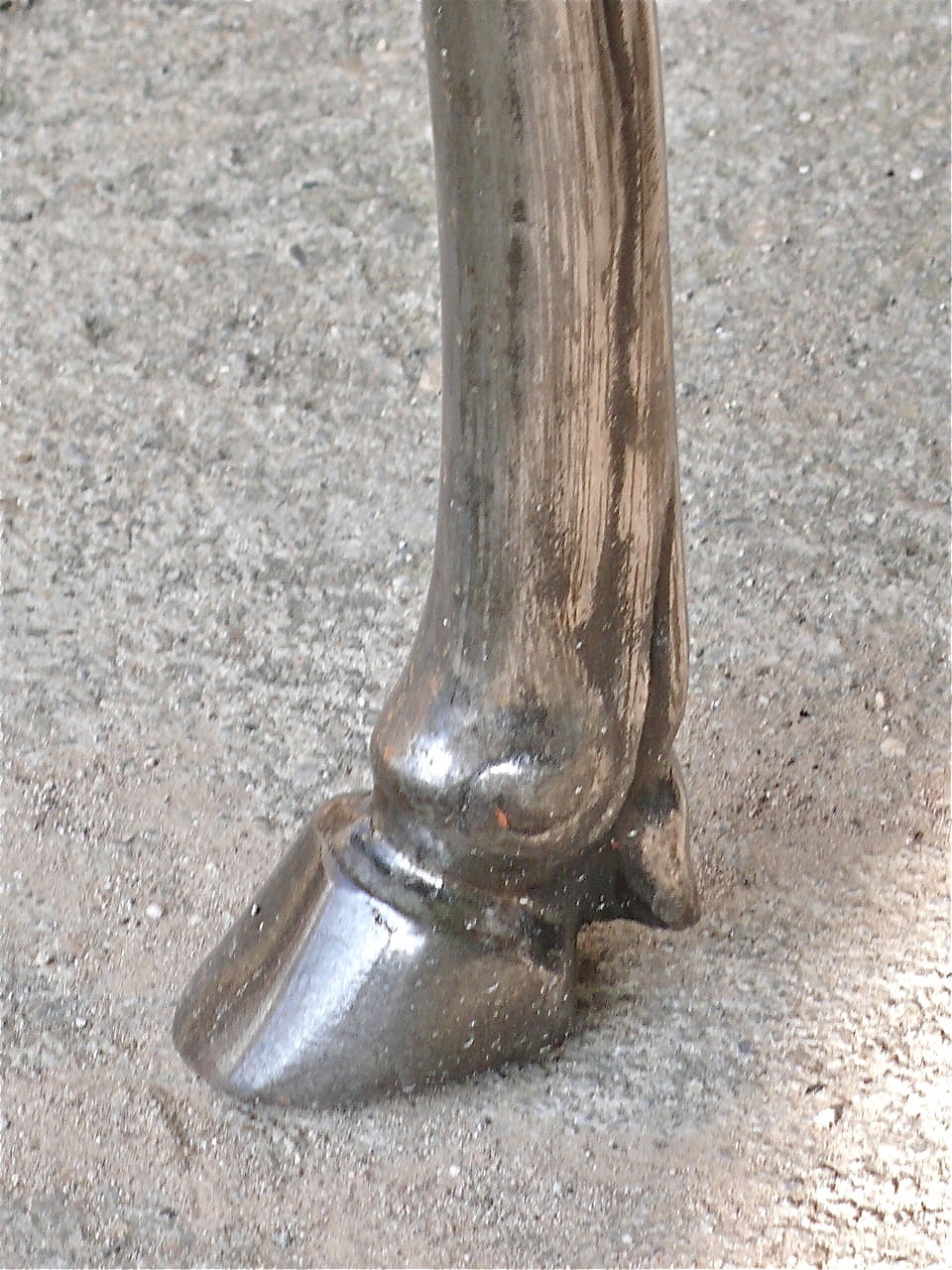 A steel center table with decorative cast horse heads and hoofed feet. 
(Includes a 1/2