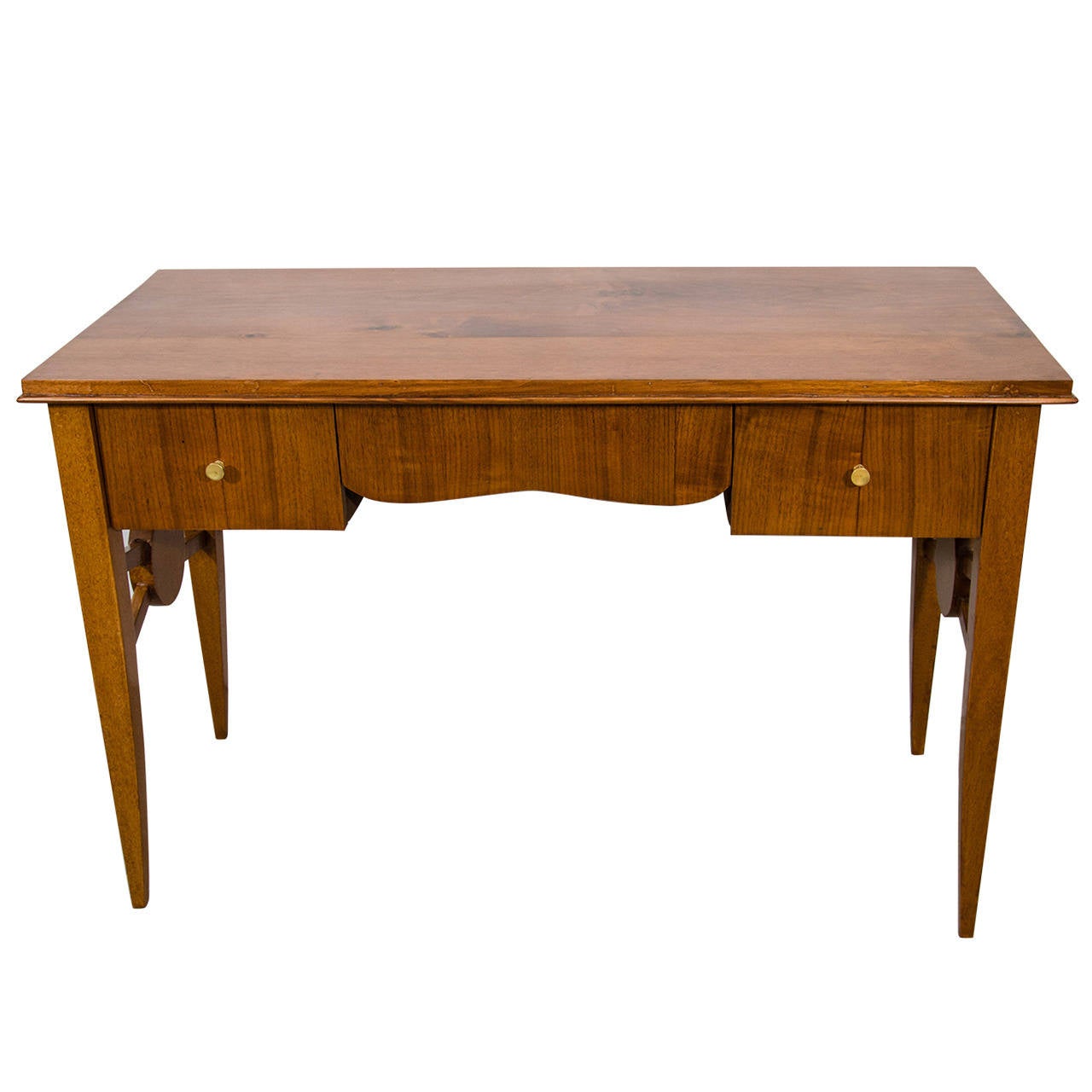 An elegant French Art Deco desk made of mahogany with three drawers, scalloped shaped apron and roundel stretcher between the front and back legs; the legs squared and tapered. The desk is finished all-around allowing for ease of placement in any