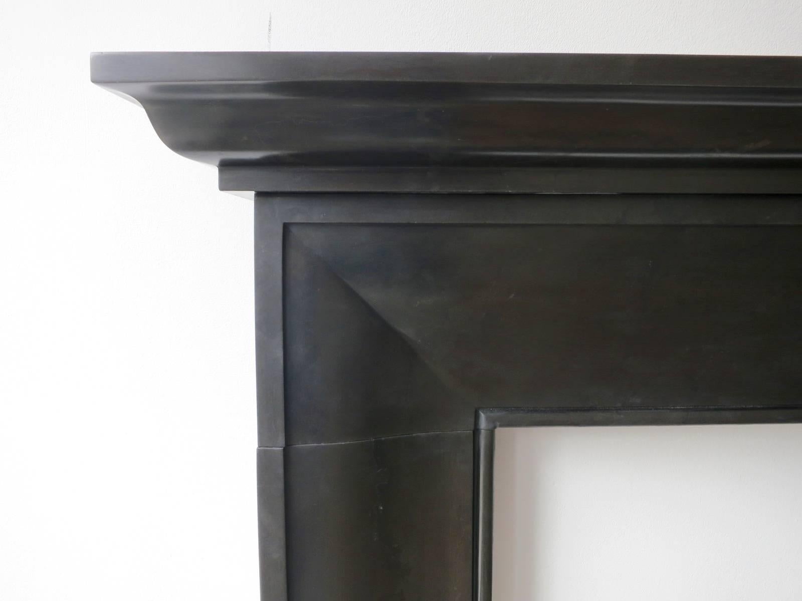 A reproduction fireplace of simple yet pleasing design, perfect for both contemporary and antique decor. A molded and shaped frame, on square foot blocks and a stepped and molded shelf above.

Opening size 103 cm W x 94.5 cm H.