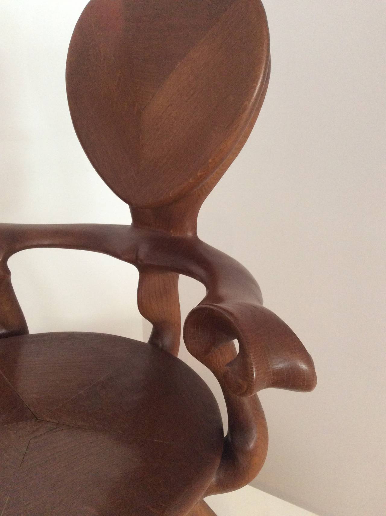 This is a Calvet armchair designed by Antoni Gaudí and manufactured by BD in Barcelona. It's made from solid varnished oak.