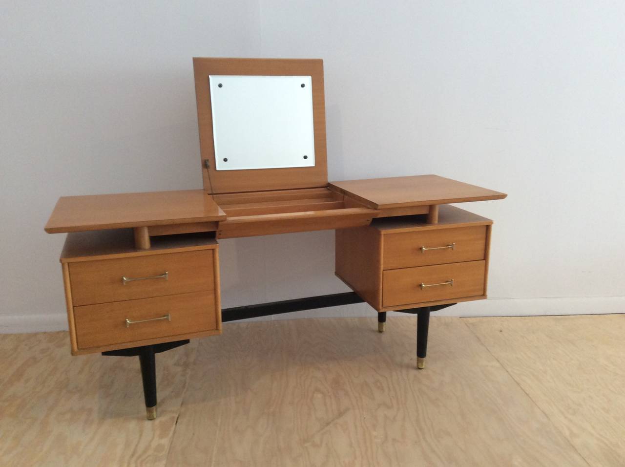 Beautiful floating top vanity by Milo Baughman for Dexel. With four drawers and lift open mirror.