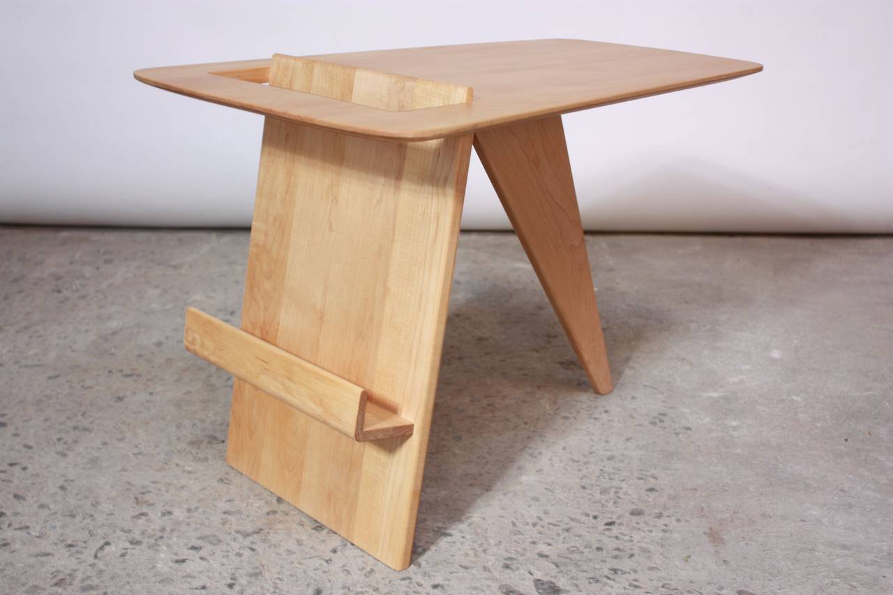 This occasional table and magazine rack was designed in 1949 by Jens Risom for Jens Risom Design. This is an early, rare birch example of this seminal design.