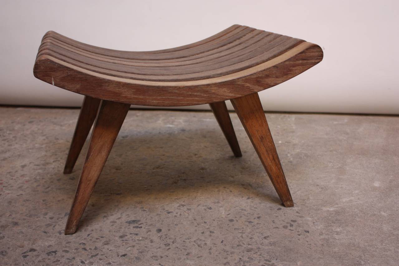 This rare bench was designed in the 1940s by the noted architect, Edward Durell Stone for Fulbright Furniture. This example bears a remarkable patina, as it was likely used outdoors, and the oak has naturally darkened from weathering the elements.