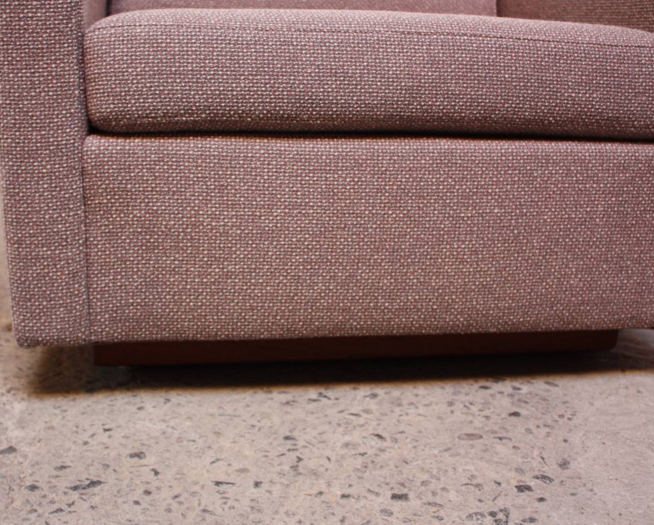 These Jack Cartwright cube lounge chairs sit on a walnut plinth base and retain their original wool tweed fabric. (The colors of the fabric are lavender, pink, and grey.) The Jack Cartwright fabric tags are intact.
The arm height is 23
