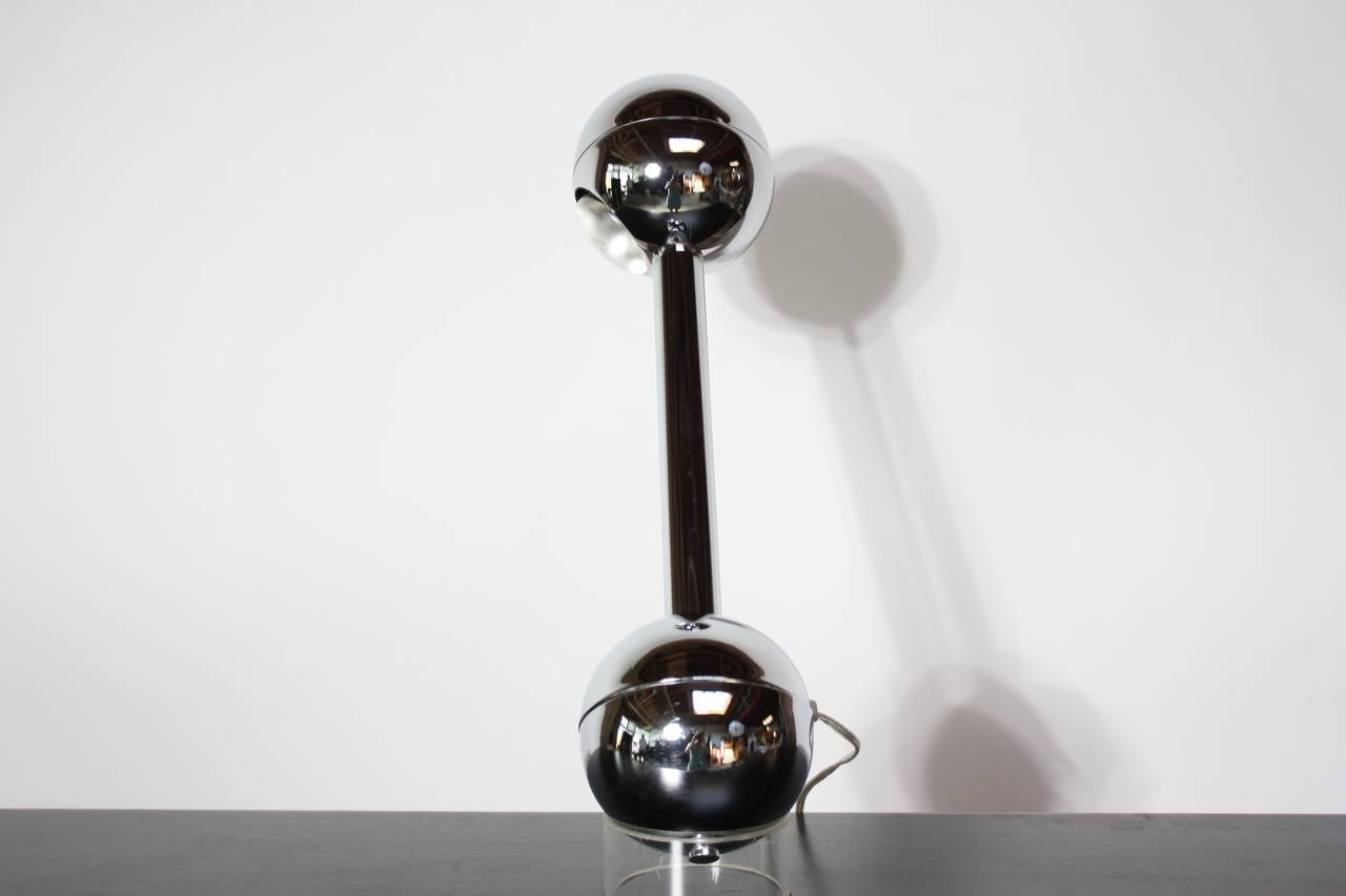 This rarely seen Pierre Cardin chrome table lamp is controlled internally by a mercury switch. This feature allows allows one to illuminate the lamp by tilting it downward. When the lamp is in the upright position, it is off. It rests upon an
