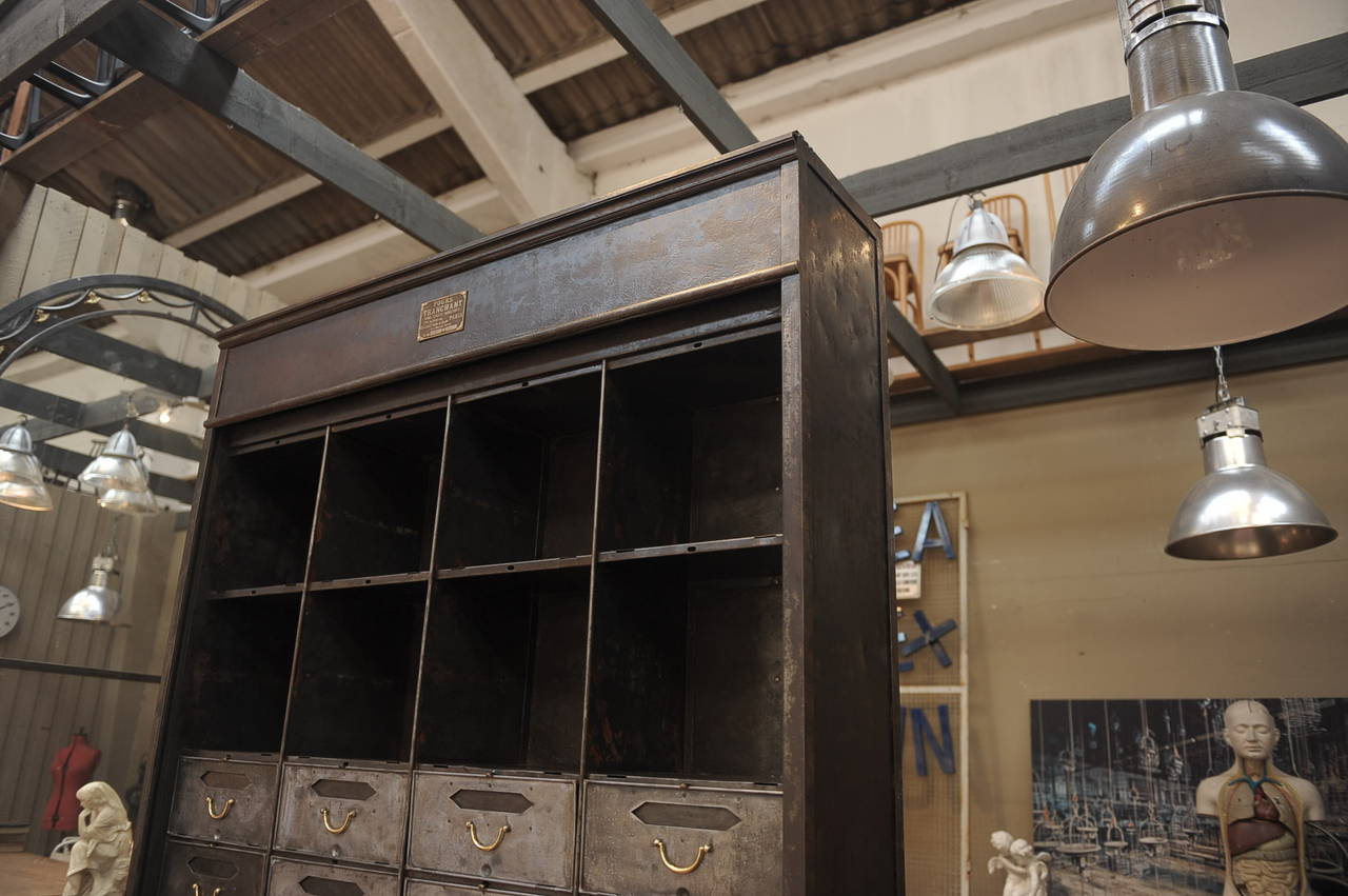 Industrial Iron and brass Compartment French Factory Drawer cabinet polished and varnished finish.