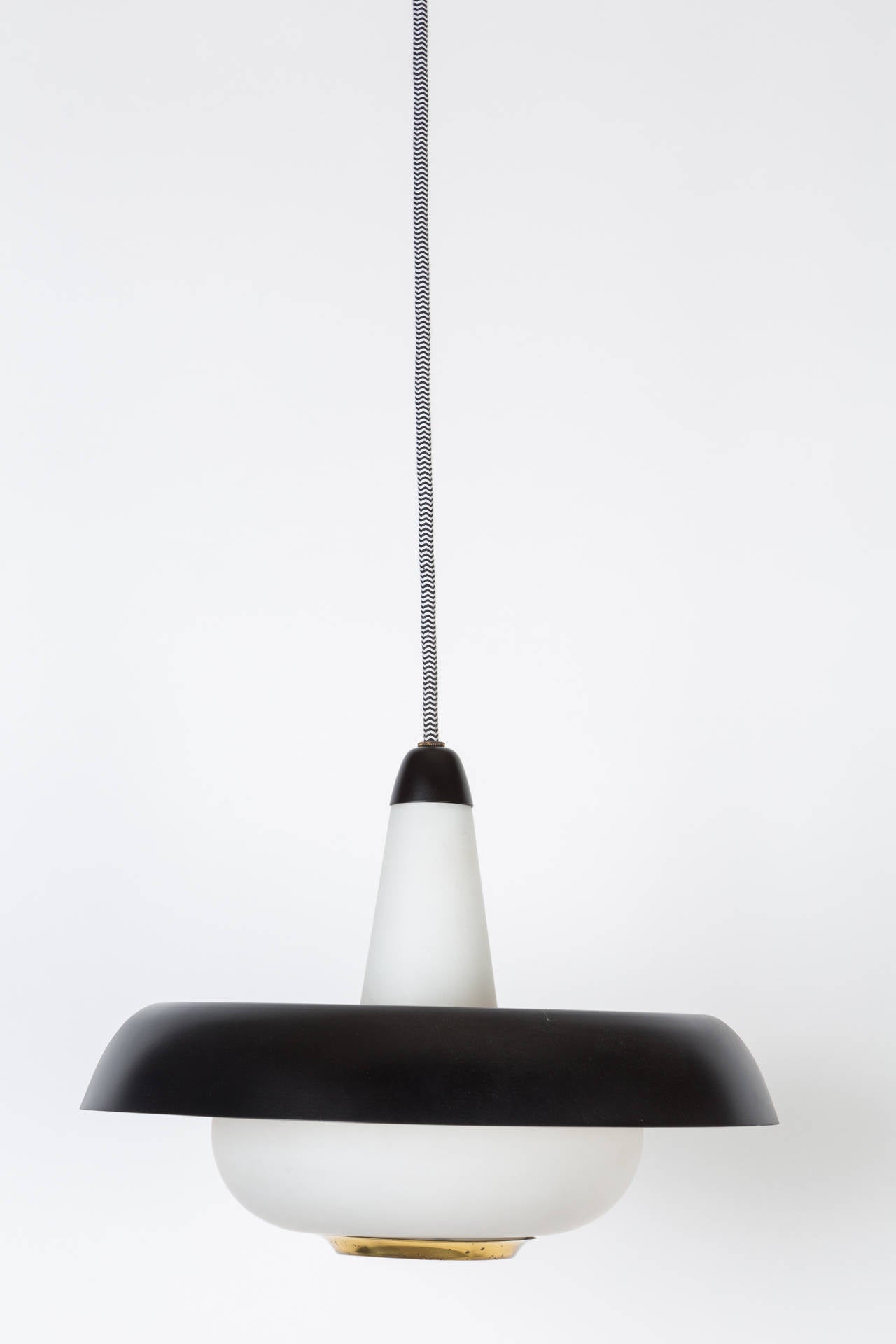 1950s Stilnovo Black Metal and Glass Pendant Lamp. Executed in opaline glass, brass and painted metal. Height is adjustable to desired length. 
