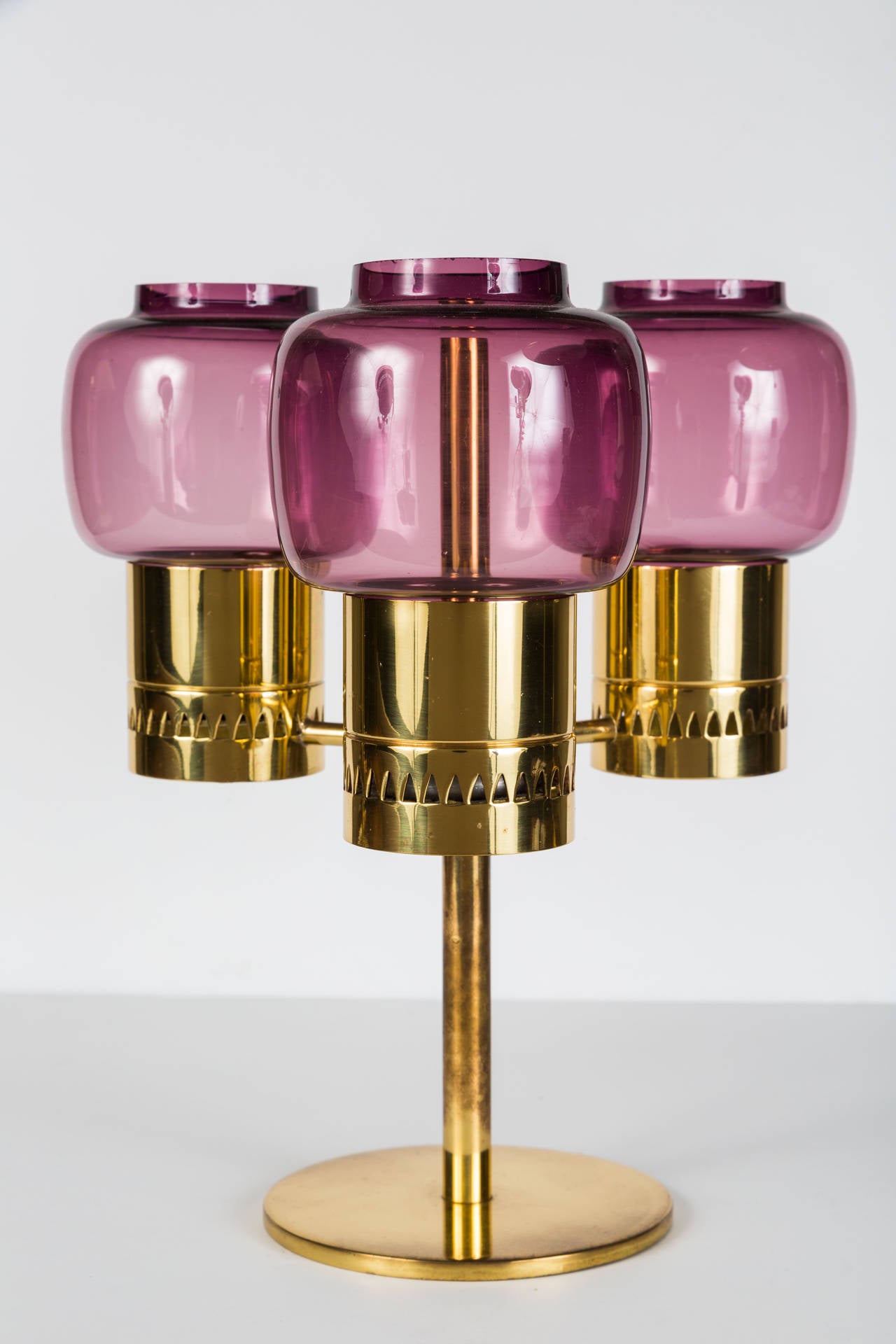 Purple glass and brass triple votive candelabra.