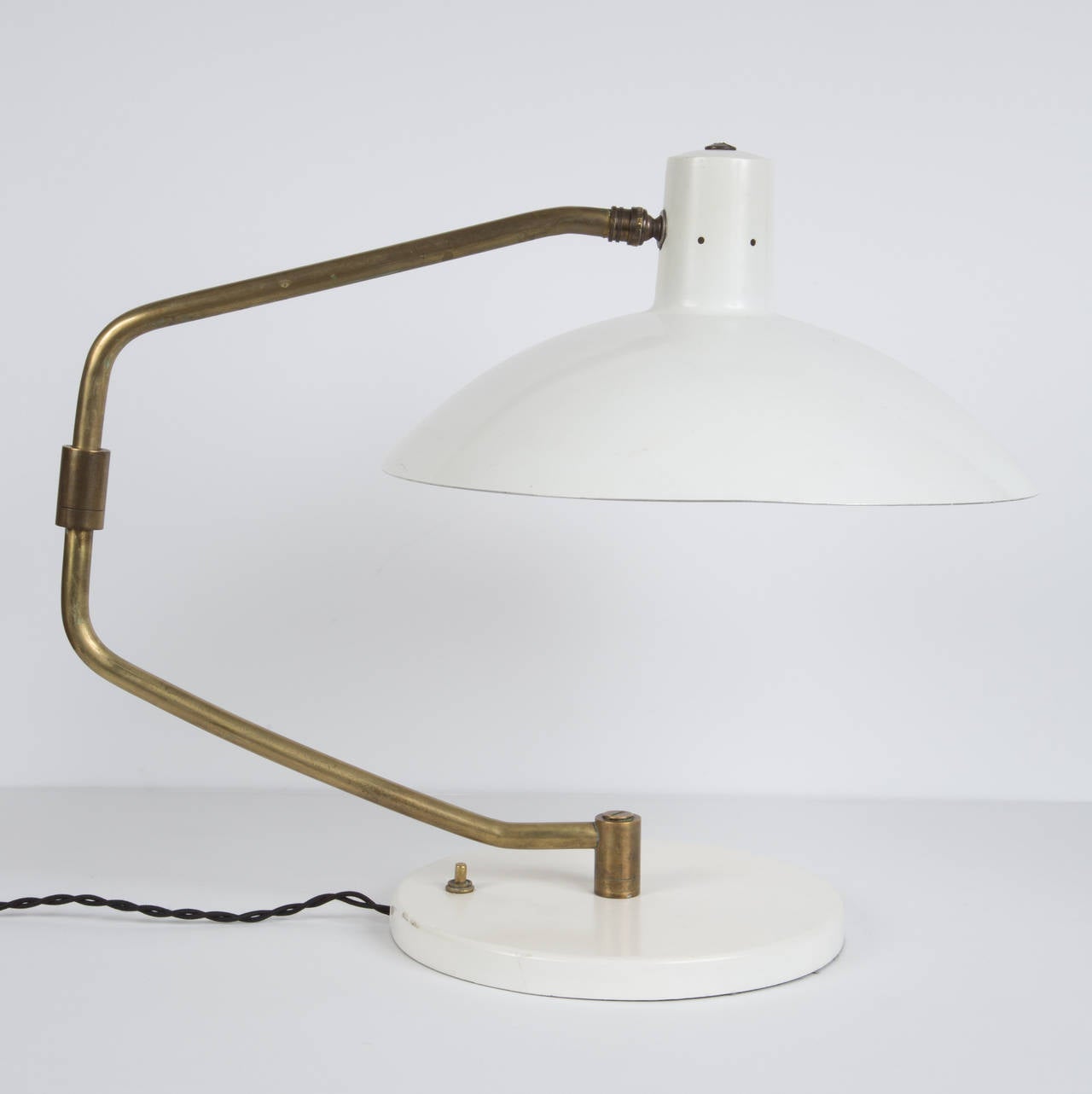 White enamel and brass. Adjustable arm and shade.