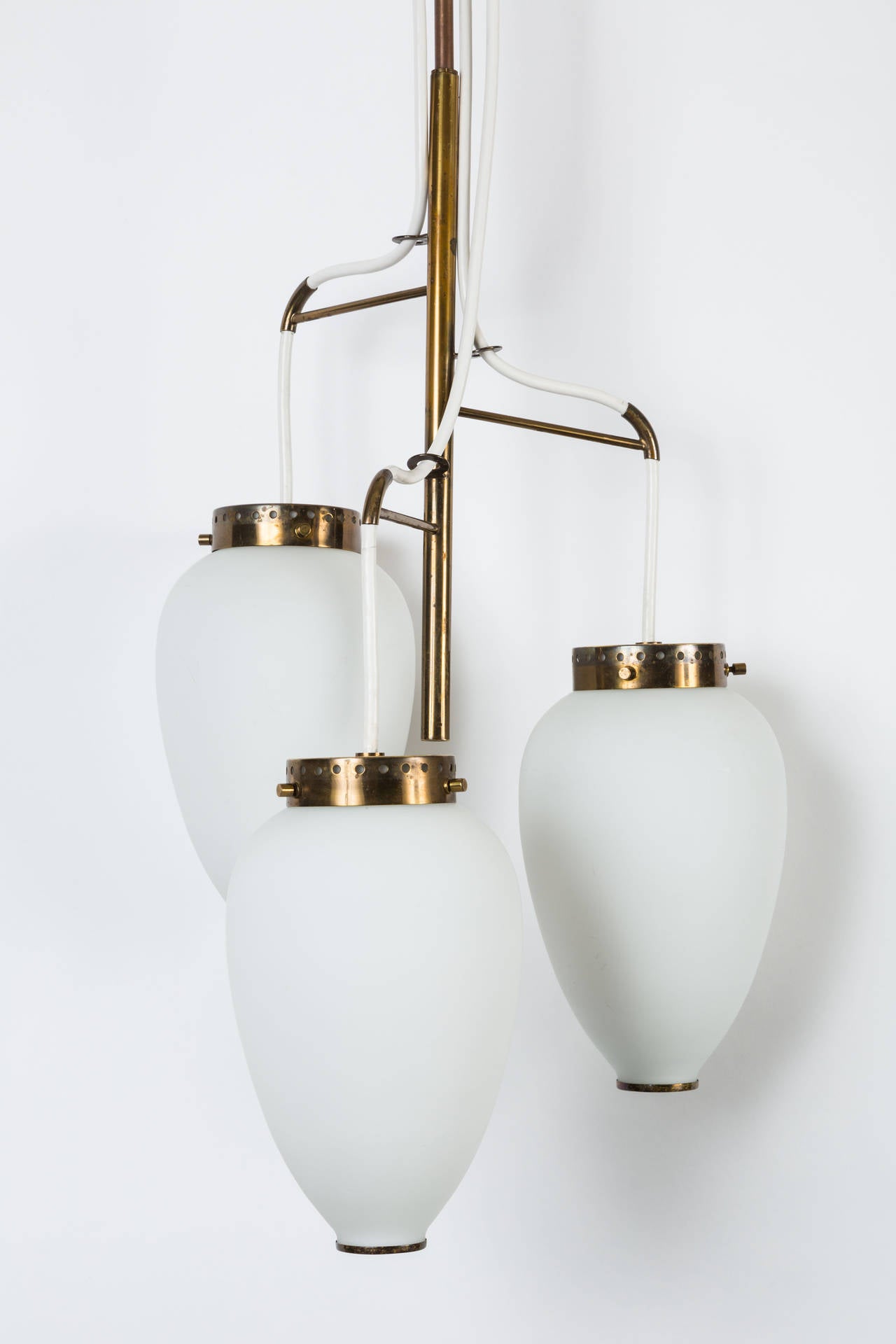 1950s Stilnovo 3-Globe Chandelier. A very elegant trio of satin finished opaline glass globes with attractively patinated brass details and armature.  Provides nice scale and a sculptural focal point with incomparable light. 

Available for viewing