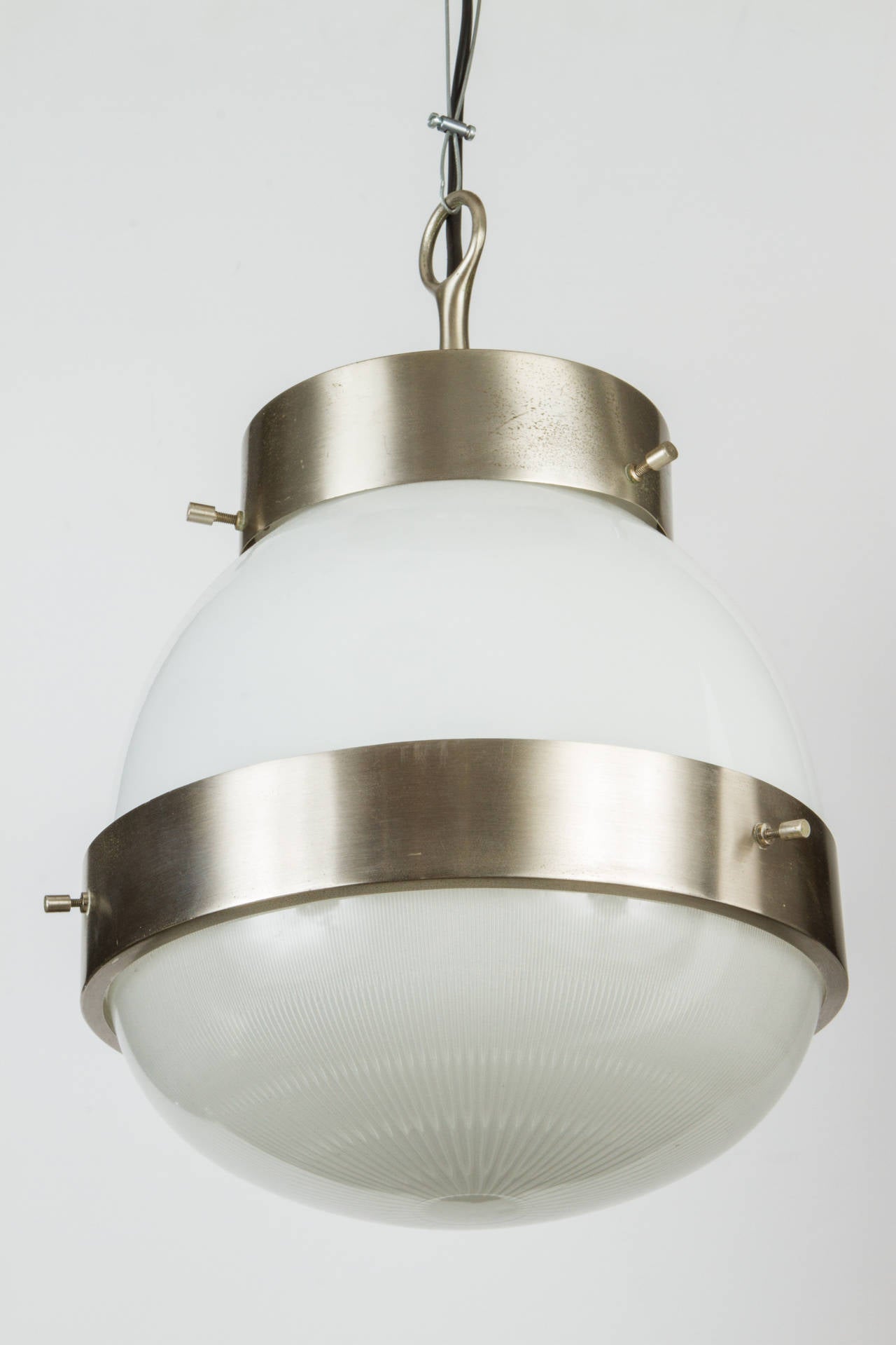 1960s Sergio Mazza 'Delta' pendant for Artemide. An architectural signature design by the incomparable Italian icon of Modernism. Executed in nickeled brass, opaline and pressed glass. 
