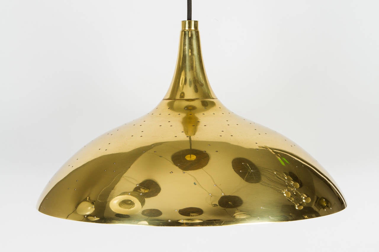 Polished perforated brass with opaque glass diffuser.