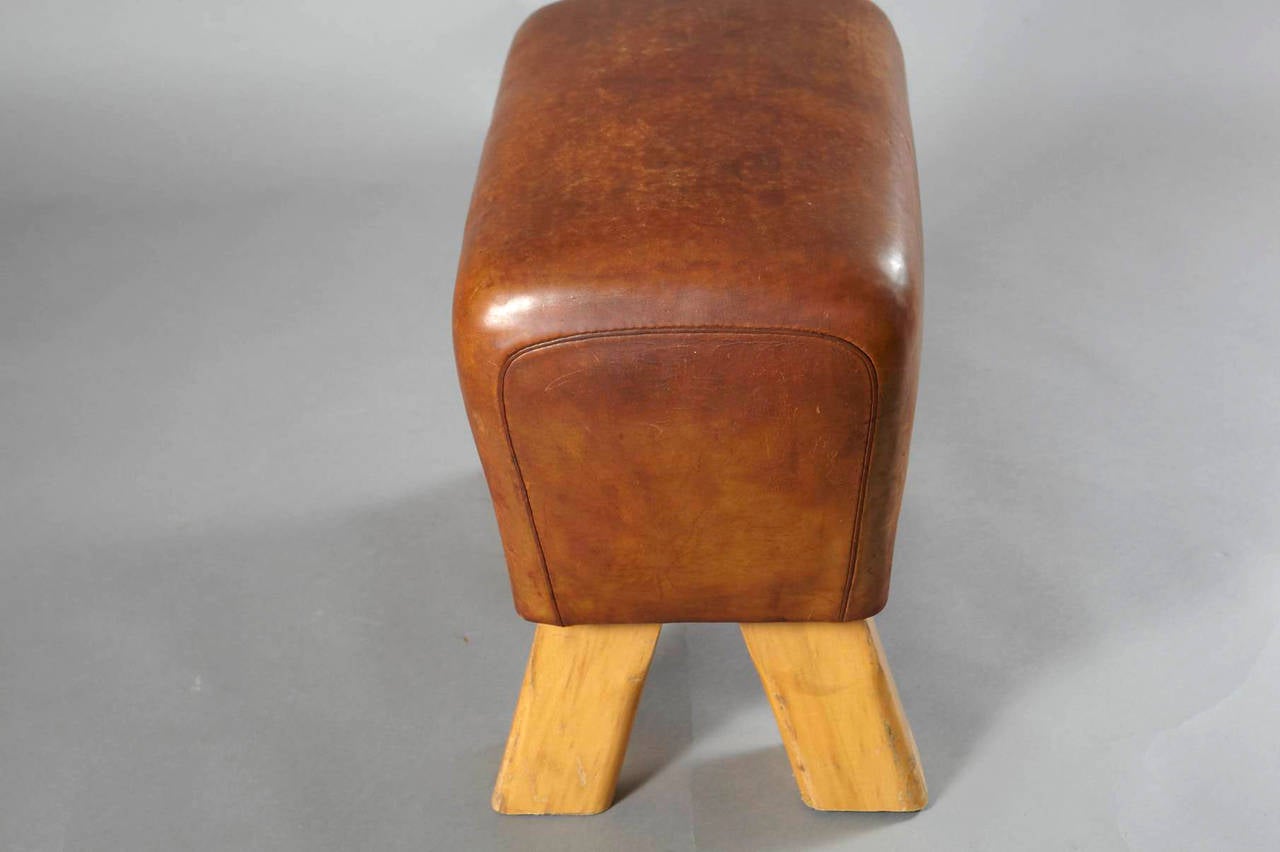 Beautiful pommel horse from Germany, circa 1960s. The legs have been shortened to make it a unique stool. Original leather with a nice patina.
A similar pommel horse stool is available to make it a pair.