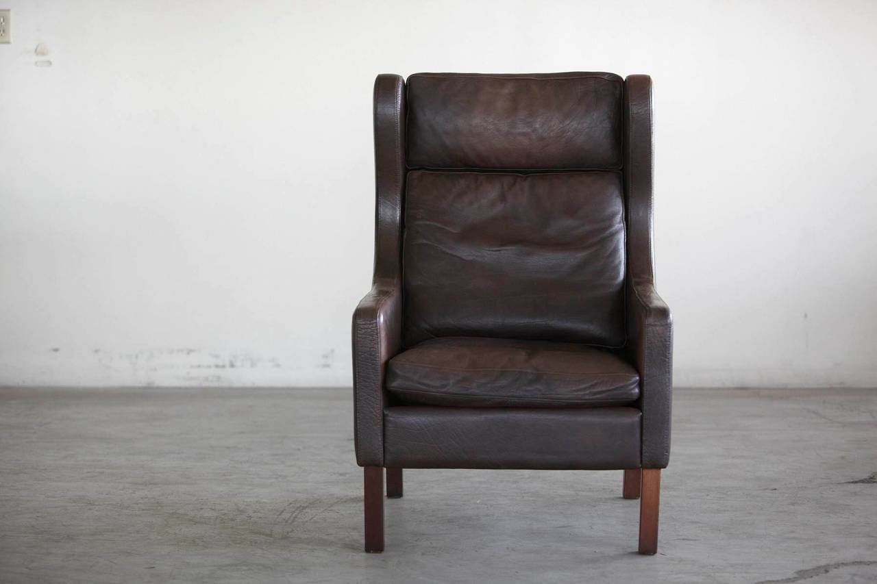 Classic Danish wingback chair in the style of Børge Mogensen. Perfect gentleman's chair with optimal comfort and style in chocolate brown leather.