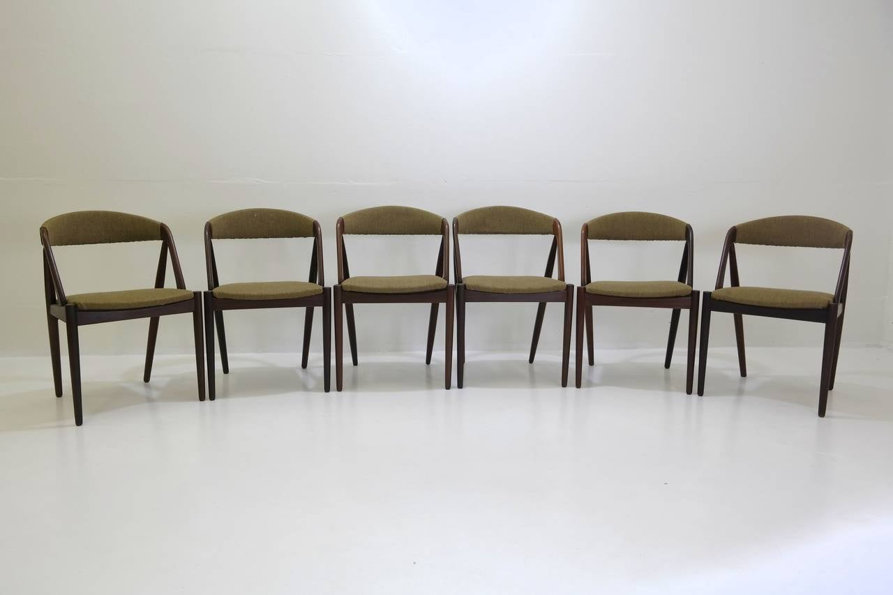 Elegant set of ten model 31 dining chairs designed by Kai Kristiansen in the 1950s. Features a solid teak frame and original wool fabric.