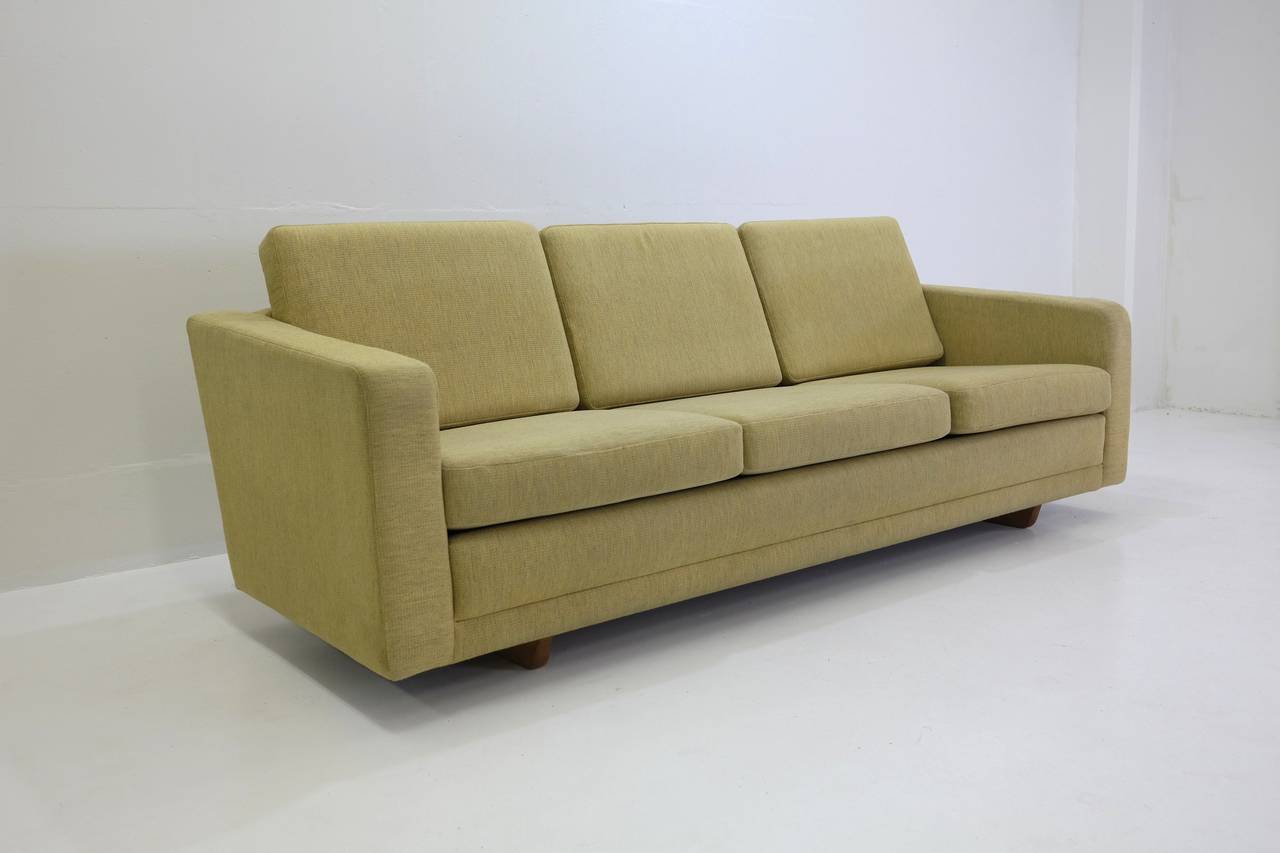 A Børge Mogensen Classic three-seat in original wool upholstery.
Age appropriate wear and patina. Original yellow wool fabric in good condition with some areas of wear to the front of armrests and a small hole in the fabric to the left rear of the