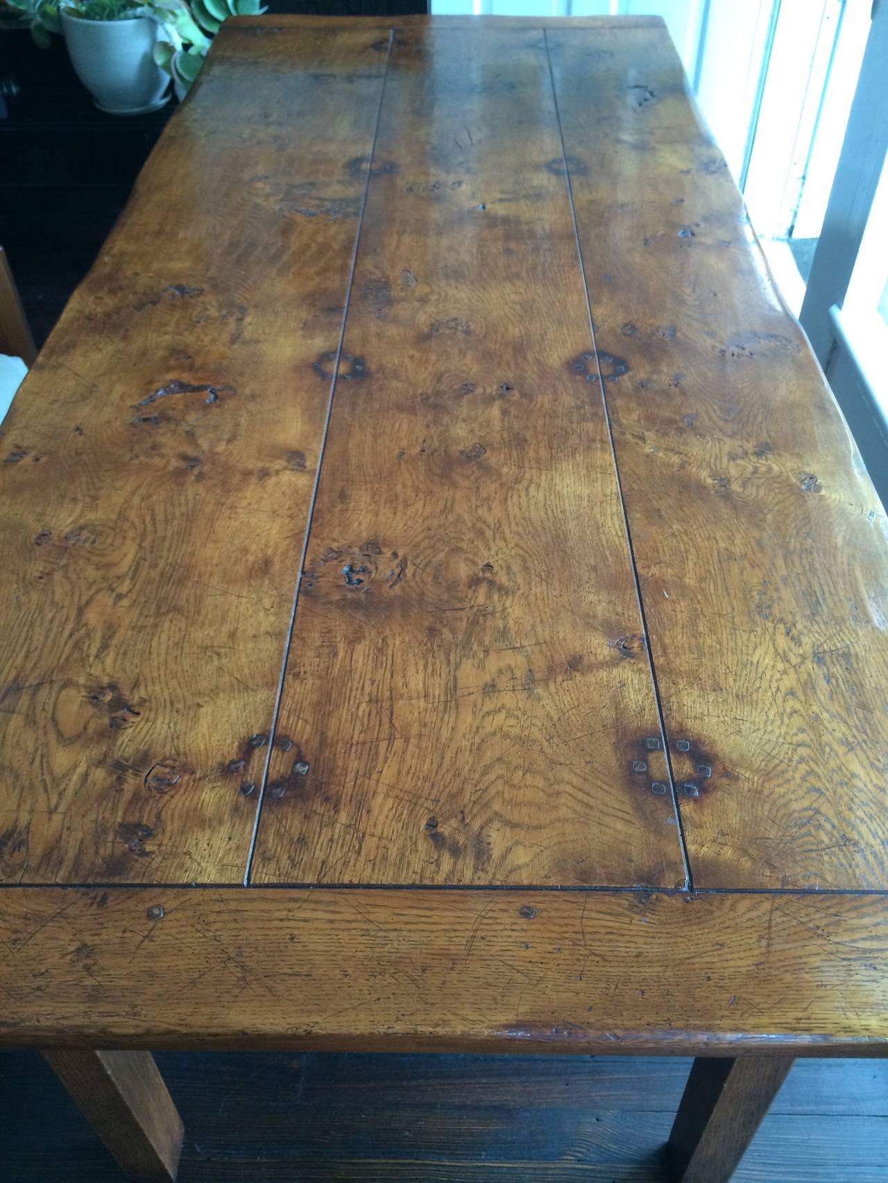 A beautiful French 19th century Chestnut farm table that will easily sit eight people.
