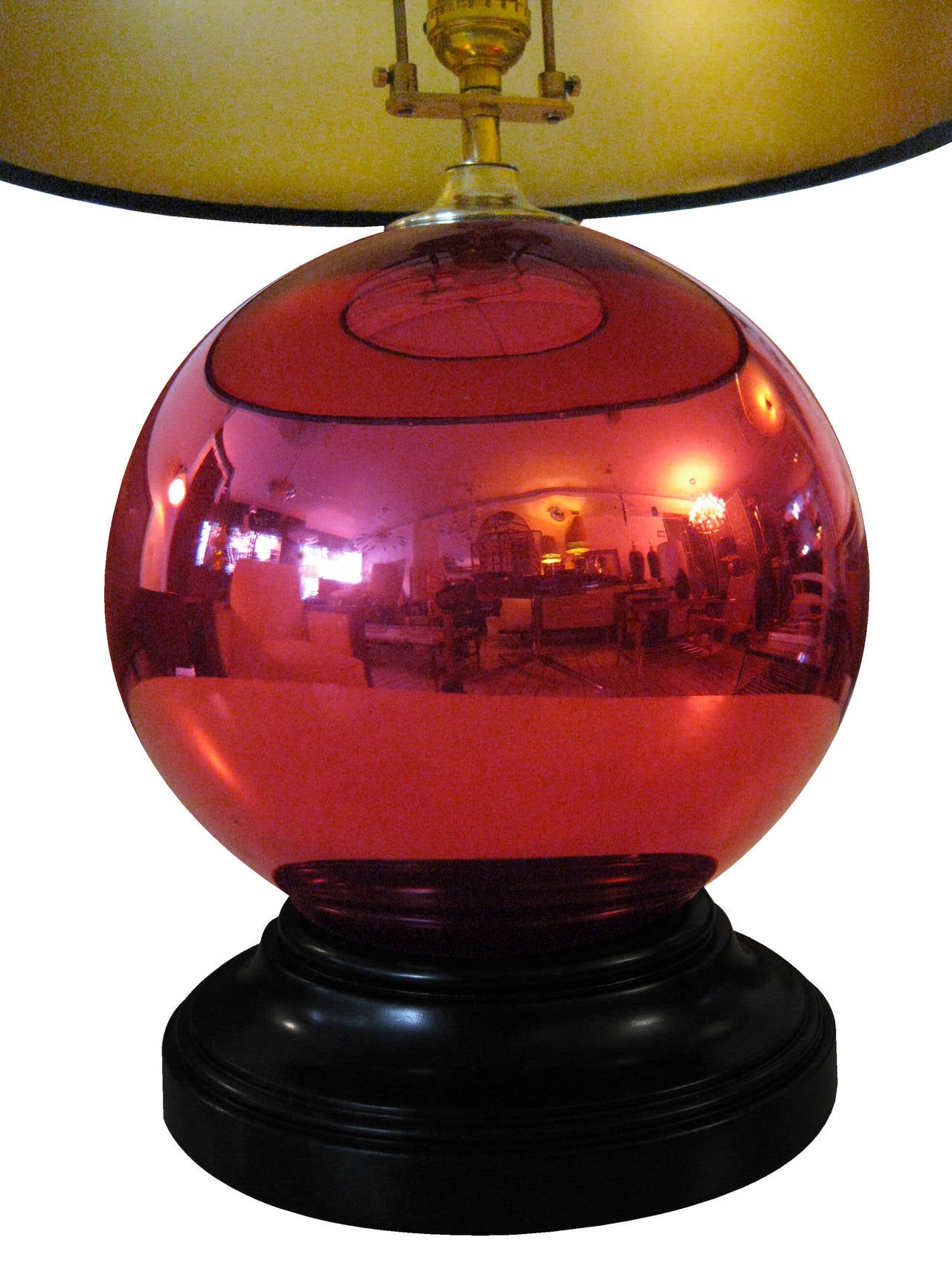 Pair of table lamps with black-lacquered mahogany bases supporting two blown-glass spheres of ruby mercury. Manufactured in Tonala, Jalisco, circa 1940. These lamps retain ALL of their original brass parts, topped with subtle shades of